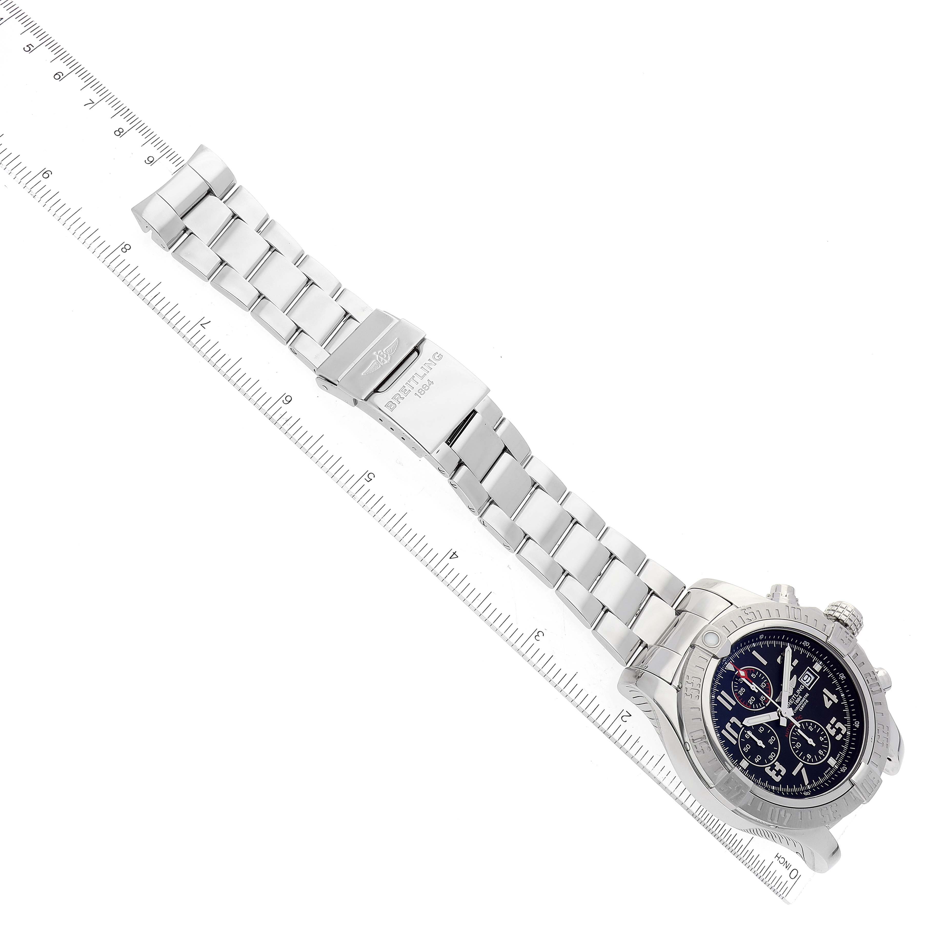 The Breitling Avenger A13371 Men's Stainless Steel Black Dial A13371 Men's Stainless Steel Black Dial watch shown is at a top-down angle, displaying its strap, clasp, and face, with a ruler for scale.