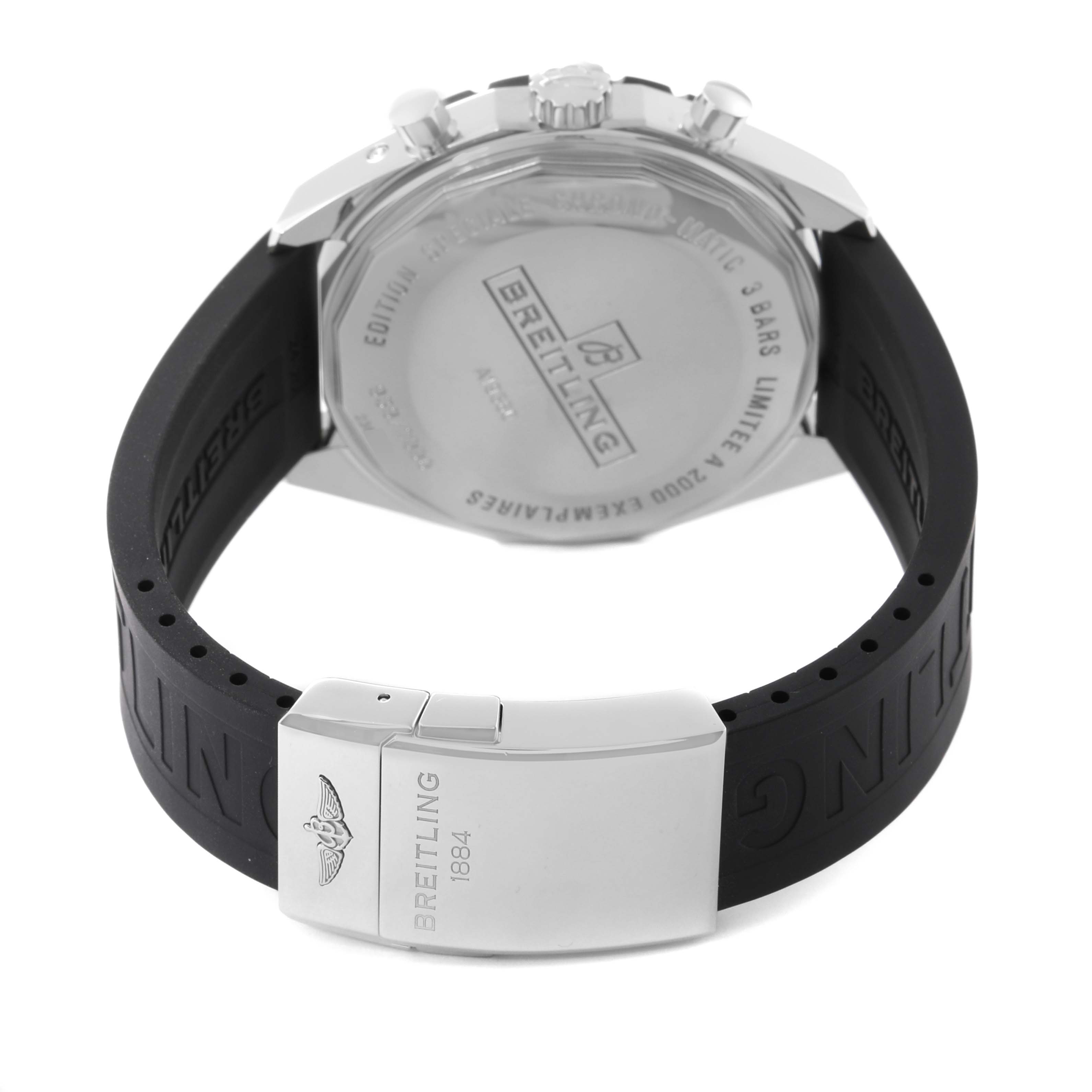 This image shows the back of a Breitling Limited Series watch and part of its black rubber strap with a metal clasp.