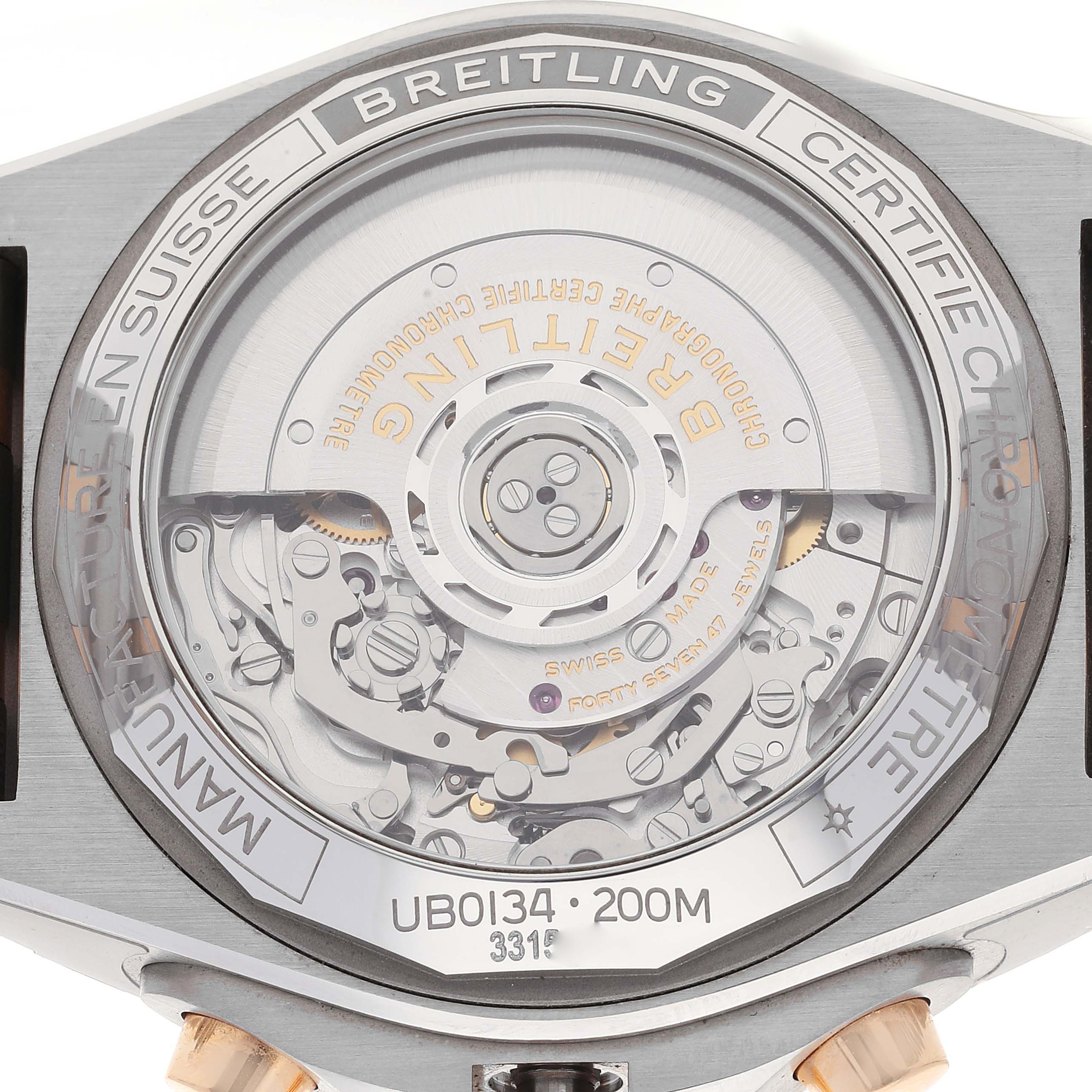 This is the back of a Breitling Chronomat UB0134 Men's Steel and Gold (two tone) Grey Dial UB0134 Men's Steel and Gold (two tone) Grey Dial watch, showing the exposed movement and internal mechanisms.