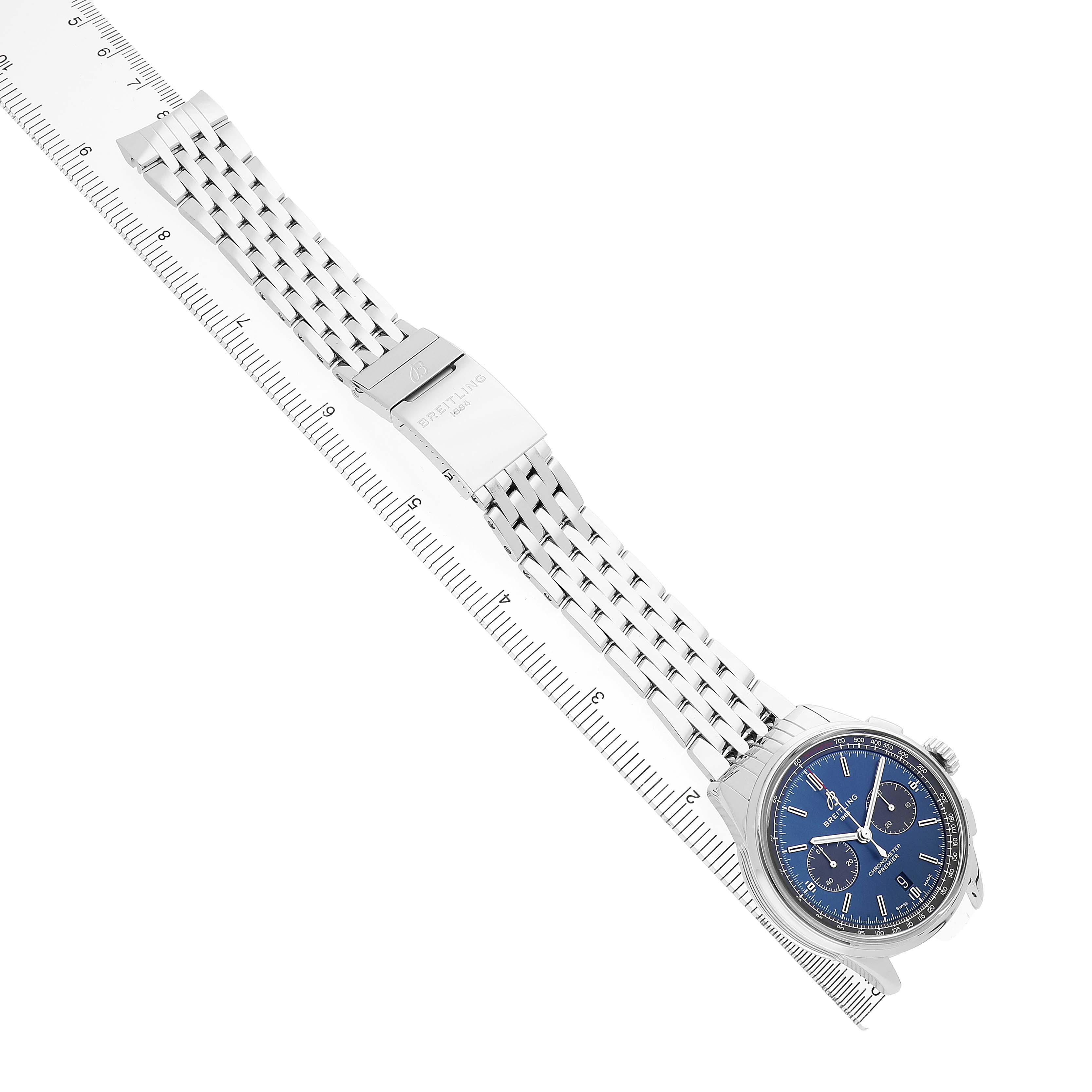 The image shows a Breitling Premier AB0118A61C1A1 Men's Stainless Steel Blue Dial watch at an angled top-down view, displaying the face, bracelet, and clasp.