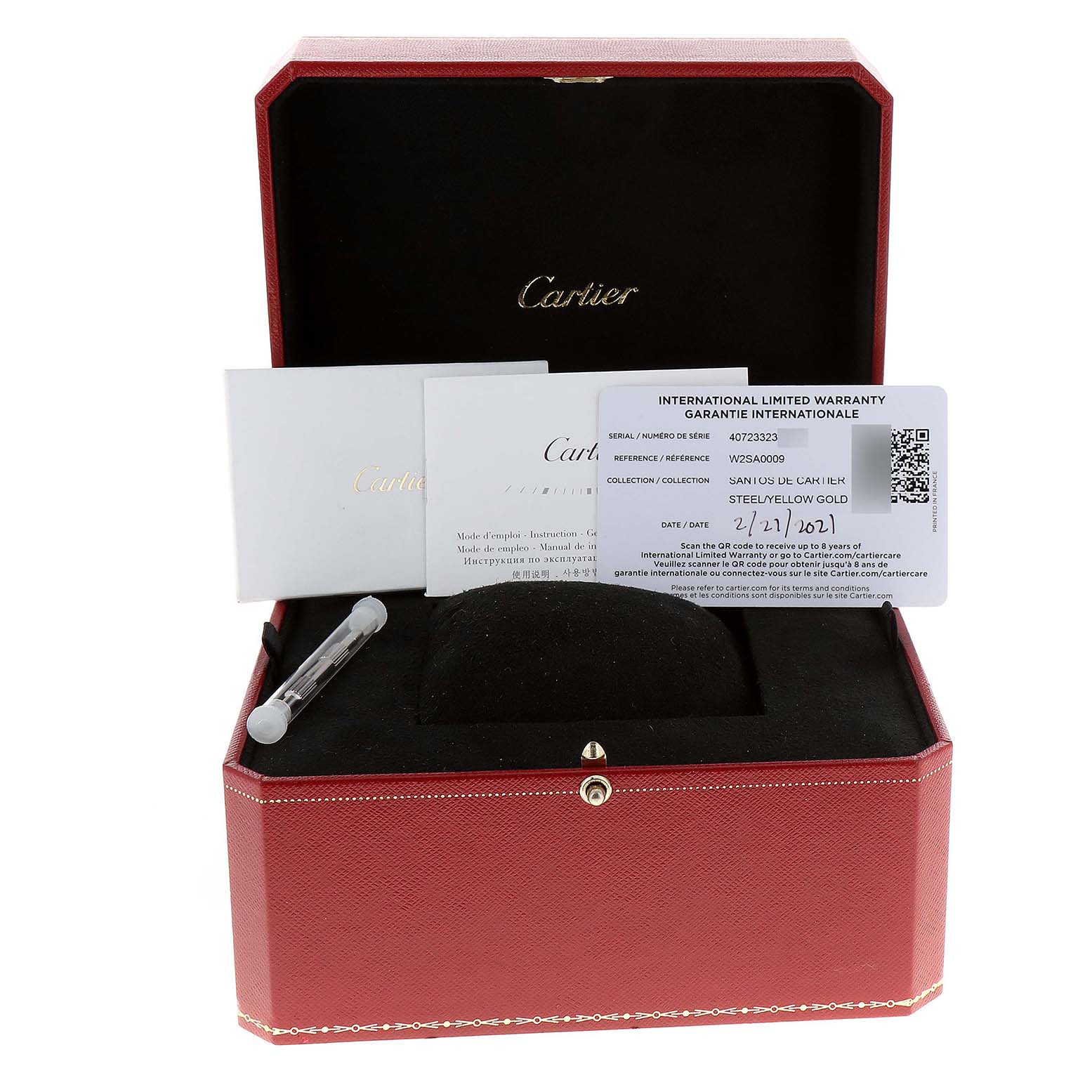 This image shows a Cartier Santos W2SA0009 Men's Steel and Gold (two tone) Silver Dial W2SA0009 Men's Steel and Gold (two tone) Silver Dial watch box with documentation and an accessory tube inside.