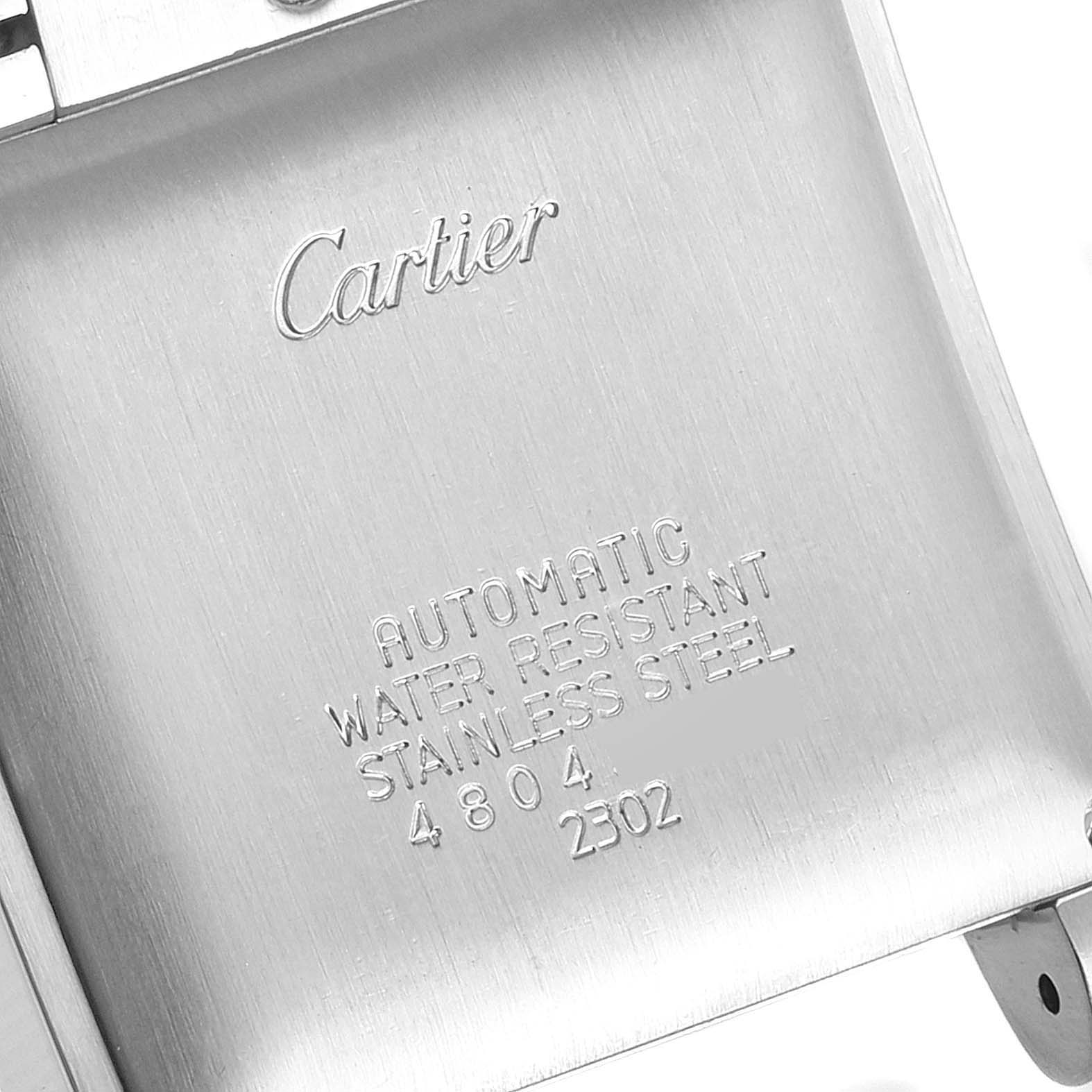 This image shows the back of a stainless steel Cartier Tank Française watch, highlighting its inscriptions and specifications.