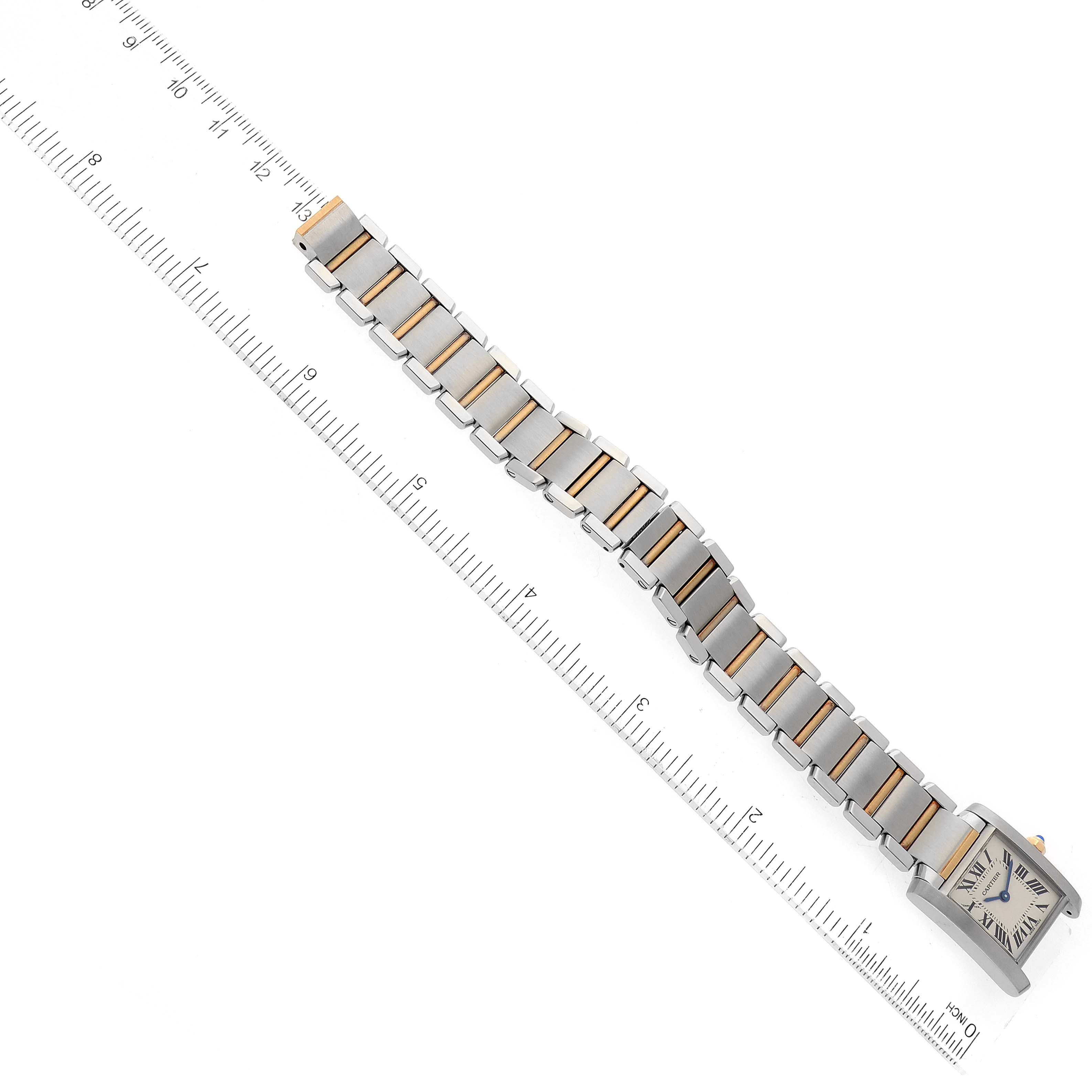 The image shows a top-down view of a Cartier Tank Française watch, including its case and full bracelet next to a ruler.
