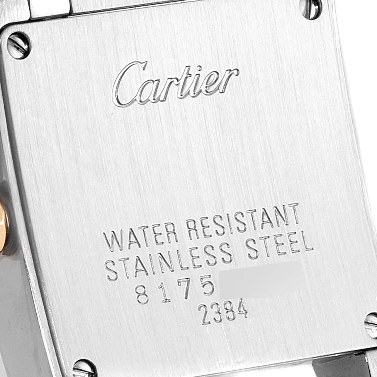 The image shows a rear view of the case back of a Cartier Tank Française watch, highlighting inscriptions about water resistance and material.