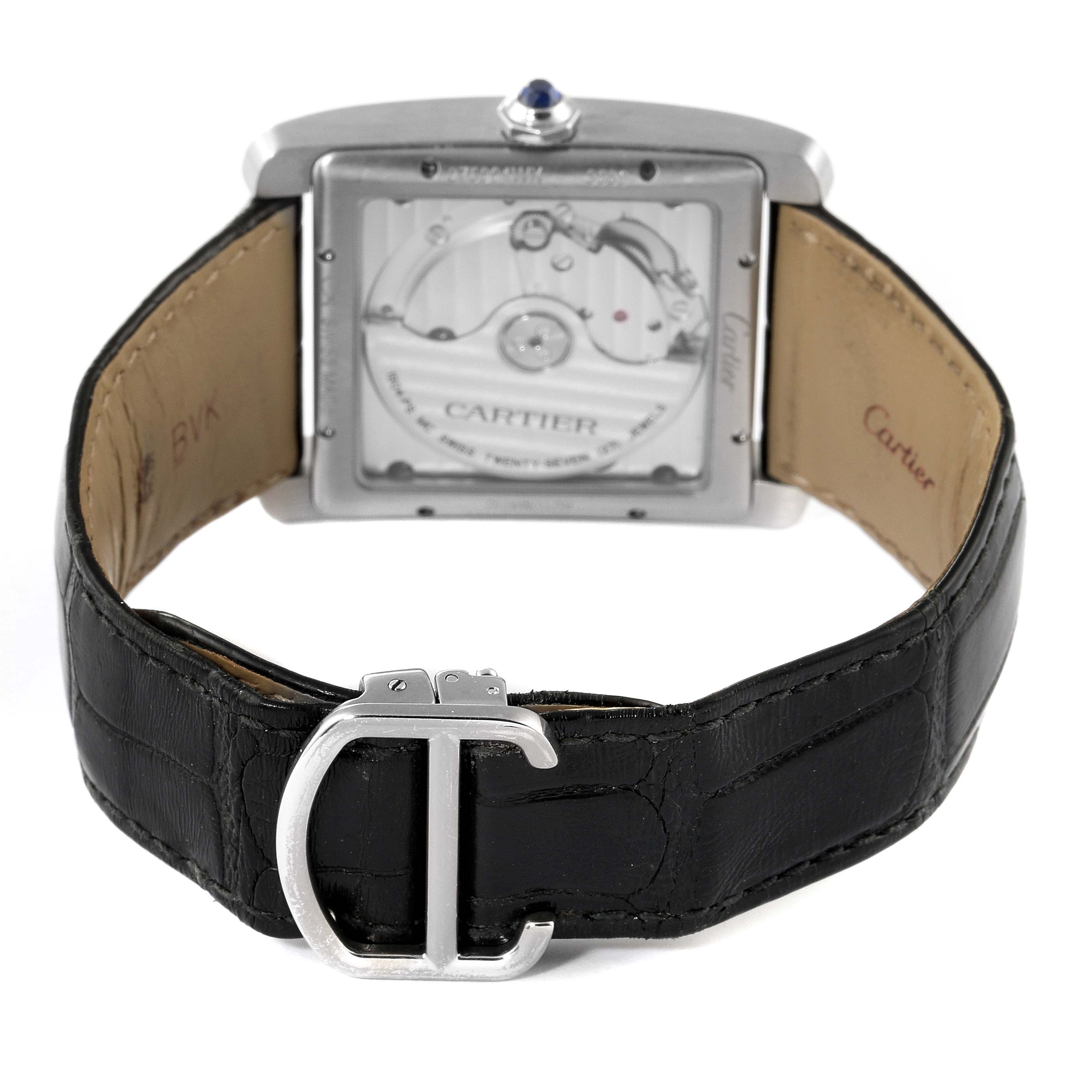 This image shows the back view of a Cartier Tank MC W5330003 Men's Stainless Steel Silver Dial W5330003 Men's Stainless Steel Silver Dial watch, highlighting the watch's movement and leather strap with a clasp.