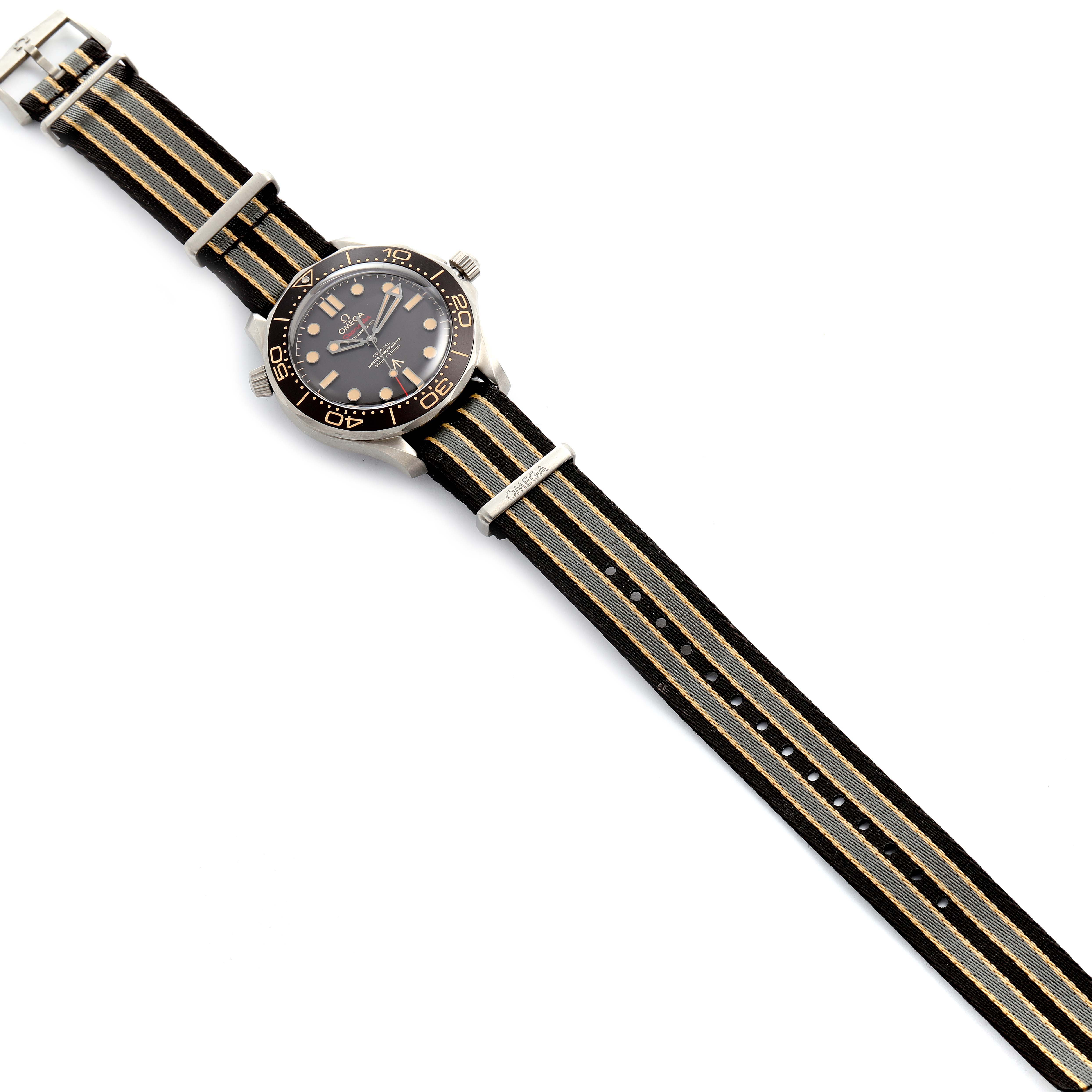 The Omega Seamaster 210.92.42.20.01.001 Men's Titanium Brown Dial 210.92.42.20.01.001 Men's Titanium Brown Dial watch is shown from a top-down angle, displaying the face and the full length of the NATO strap.