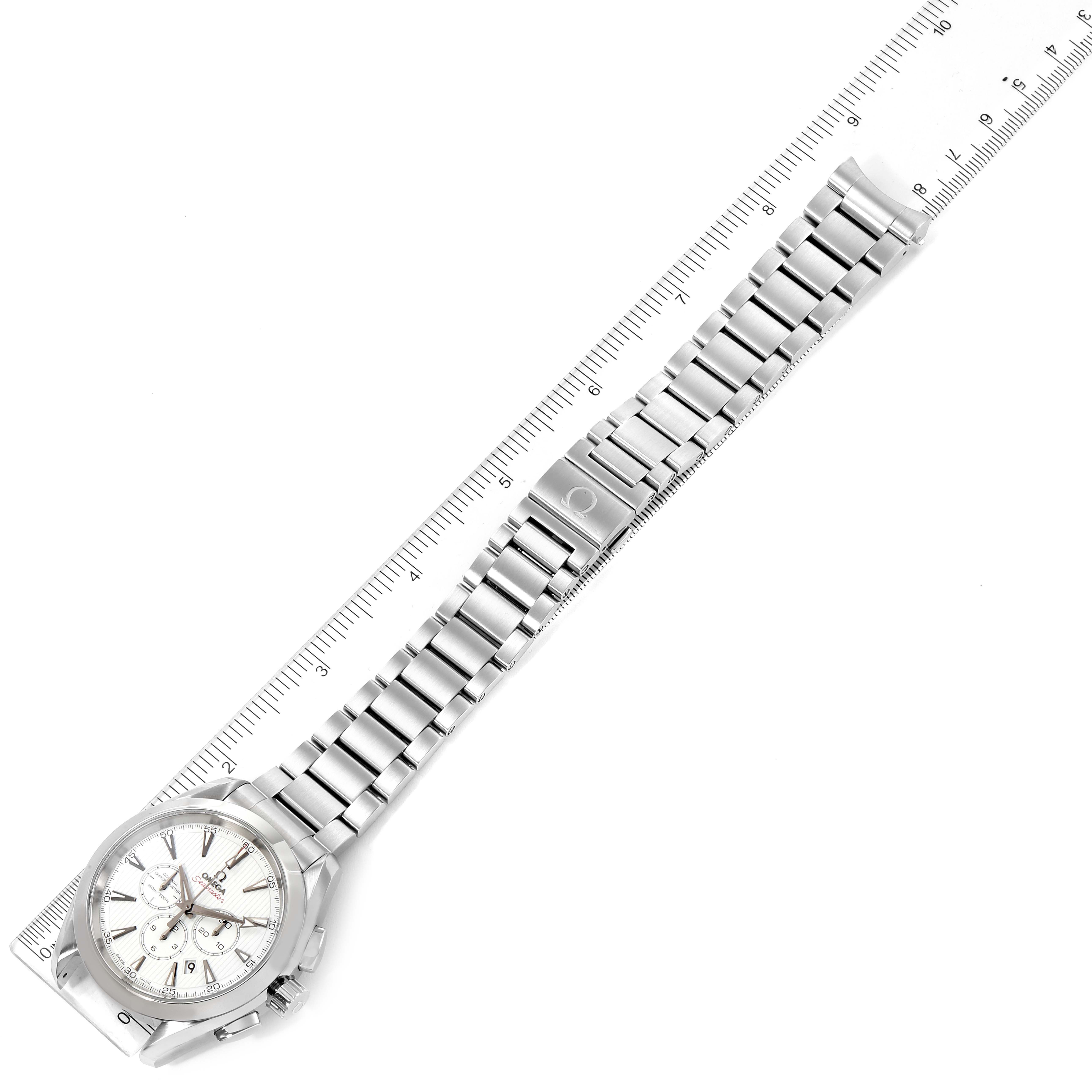 The image shows an Omega Aqua Terra 231.10.44.50.04.001 Men's Stainless Steel White Dial 231.10.44.50.04.001 Men's Stainless Steel White Dial watch laid flat next to a ruler, displaying its entire metal bracelet and face.
