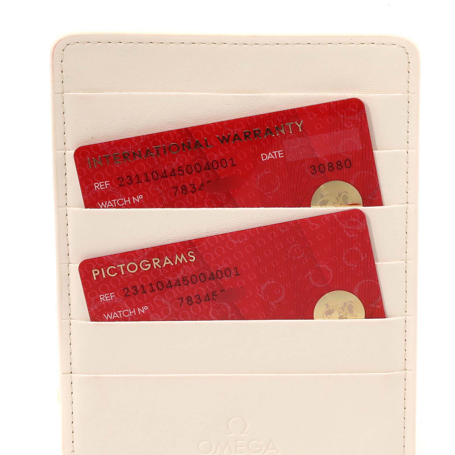 The image shows the warranty and pictogram cards for the Omega Aqua Terra 231.10.44.50.04.001 Men's Stainless Steel White Dial 231.10.44.50.04.001 Men's Stainless Steel White Dial model, placed in a white leather cardholder.