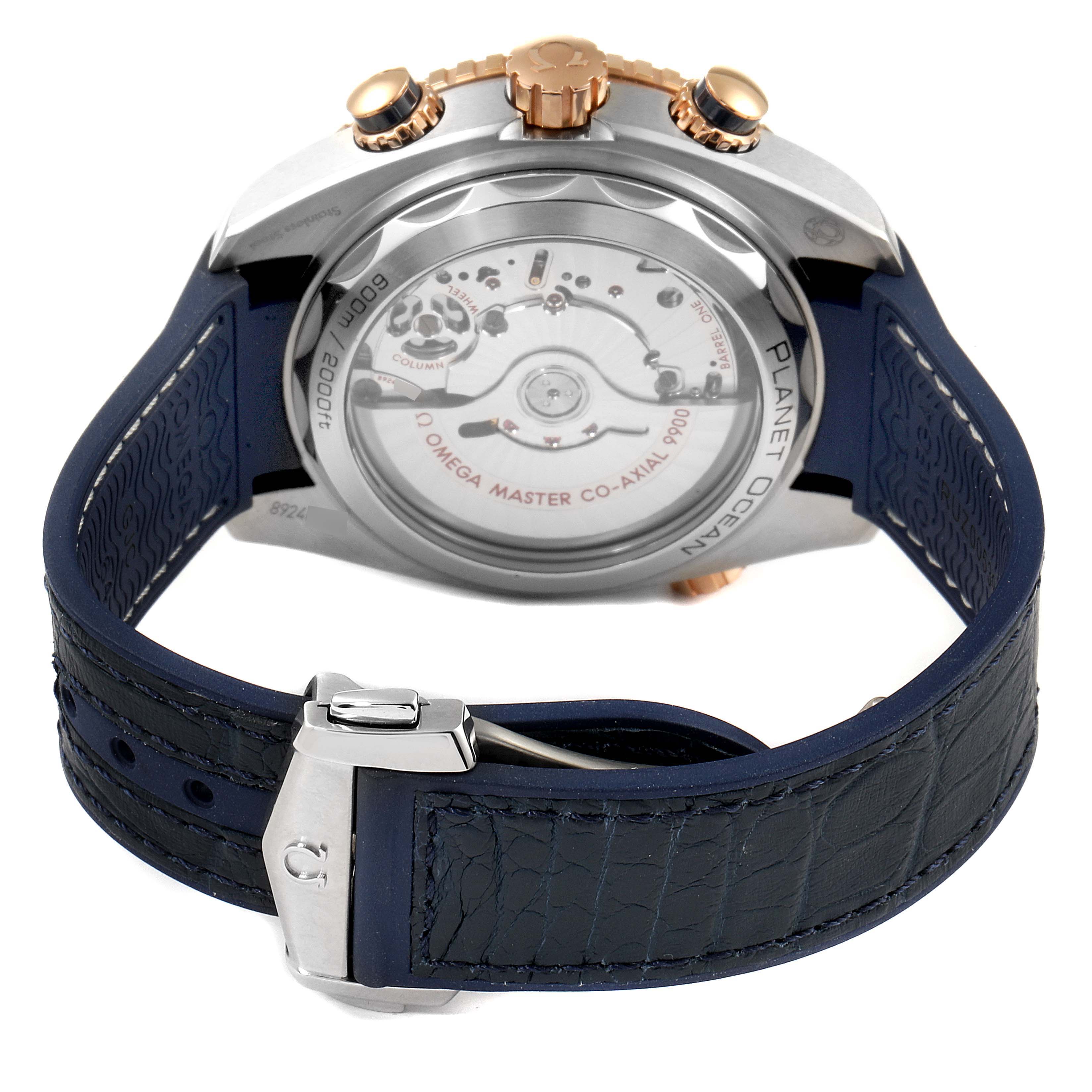 The image shows the back and strap of an Omega Planet Ocean 215.23.46.51.03.001 Men's Steel and Gold (two tone) Blue Dial 215.23.46.51.03.001 Men's Steel and Gold (two tone) Blue Dial watch, highlighting the transparent caseback and deployment clasp.
