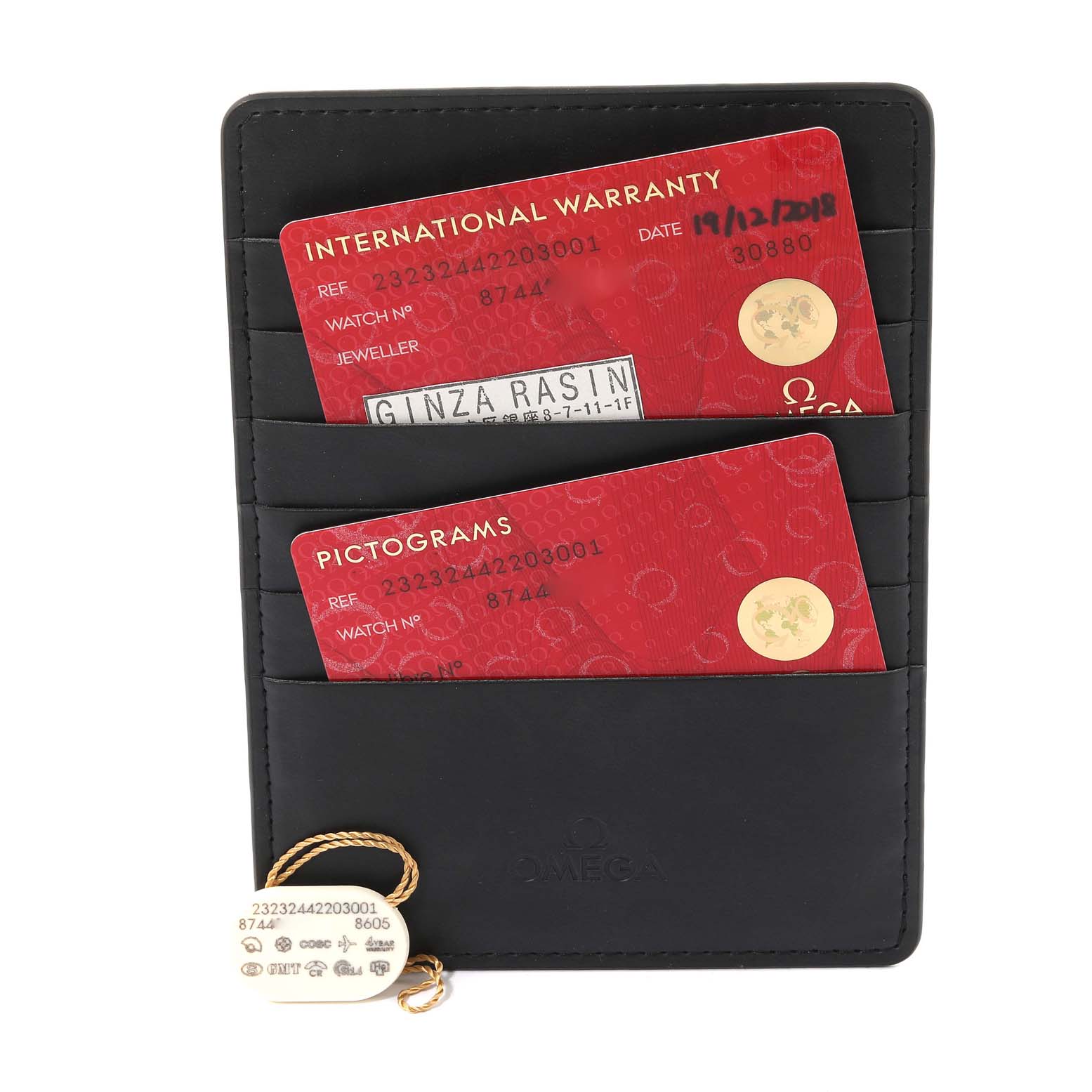 The image shows warranty cards and a tag for the Omega Planet Ocean 232.32.44.22.03.001 Men
s Stainless Steel Blue Dial 232.32.44.22.03.001 Men
s Stainless Steel Blue Dial model, displayed in a black card holder.