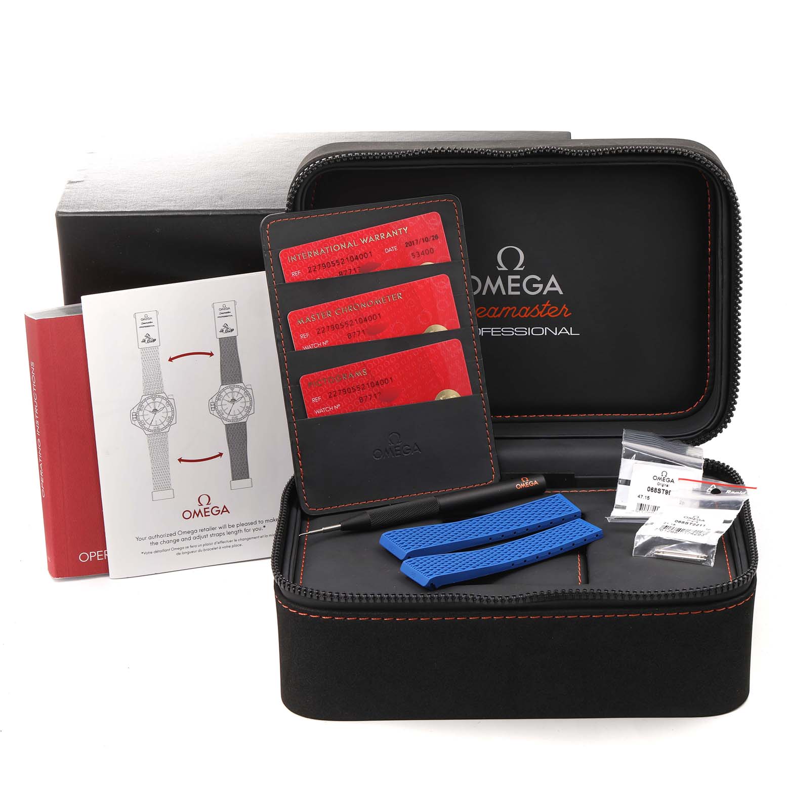 The image shows accessories for an Omega Ploprof 227.90.55.21.04.001 Men's Titanium White Dial 227.90.55.21.04.001 Men's Titanium White Dial watch, including a case, documentation, cards, a strap, and tools.