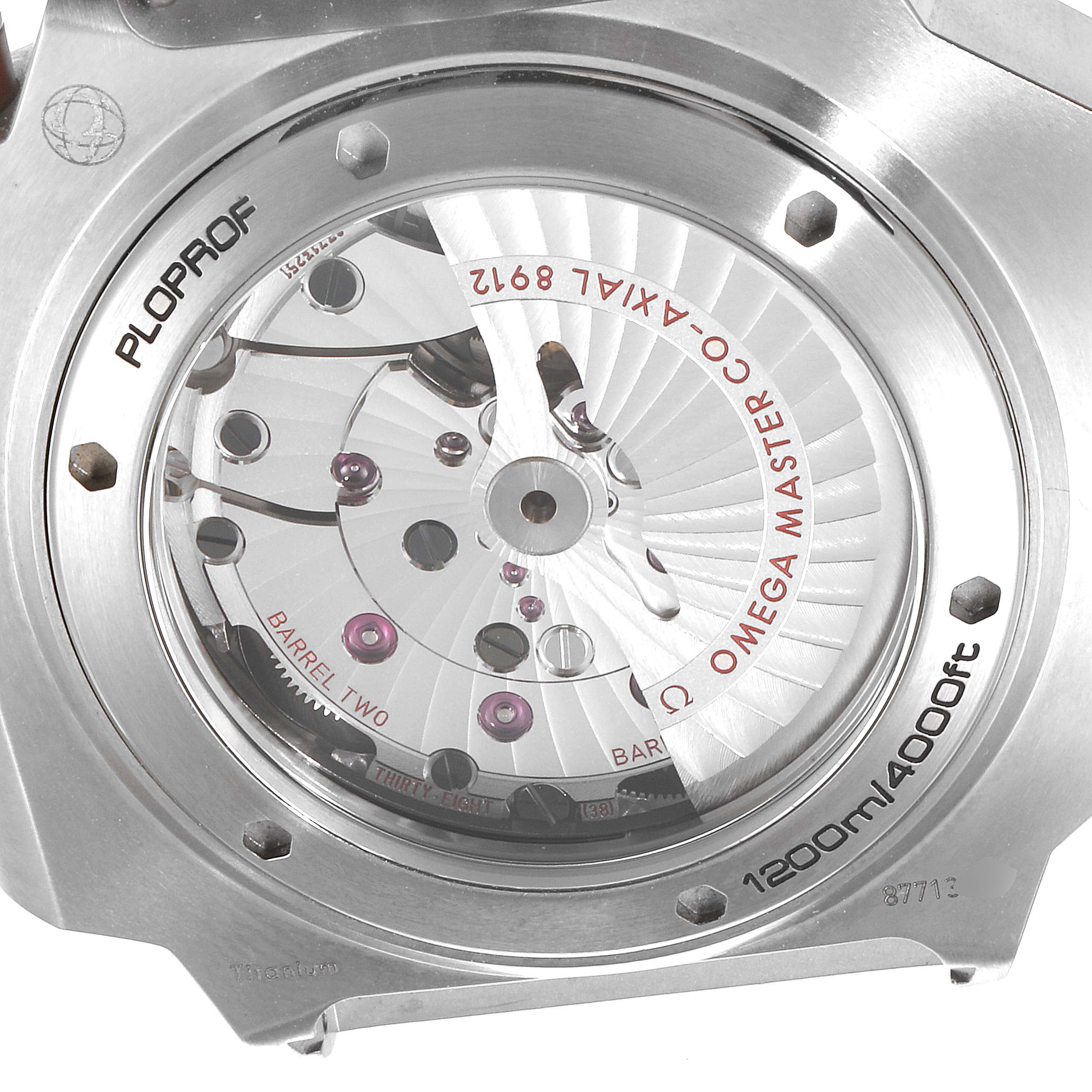 The image shows a close-up of the movement through the transparent case back of an Omega Ploprof 227.90.55.21.04.001 Men's Titanium White Dial 227.90.55.21.04.001 Men's Titanium White Dial watch.