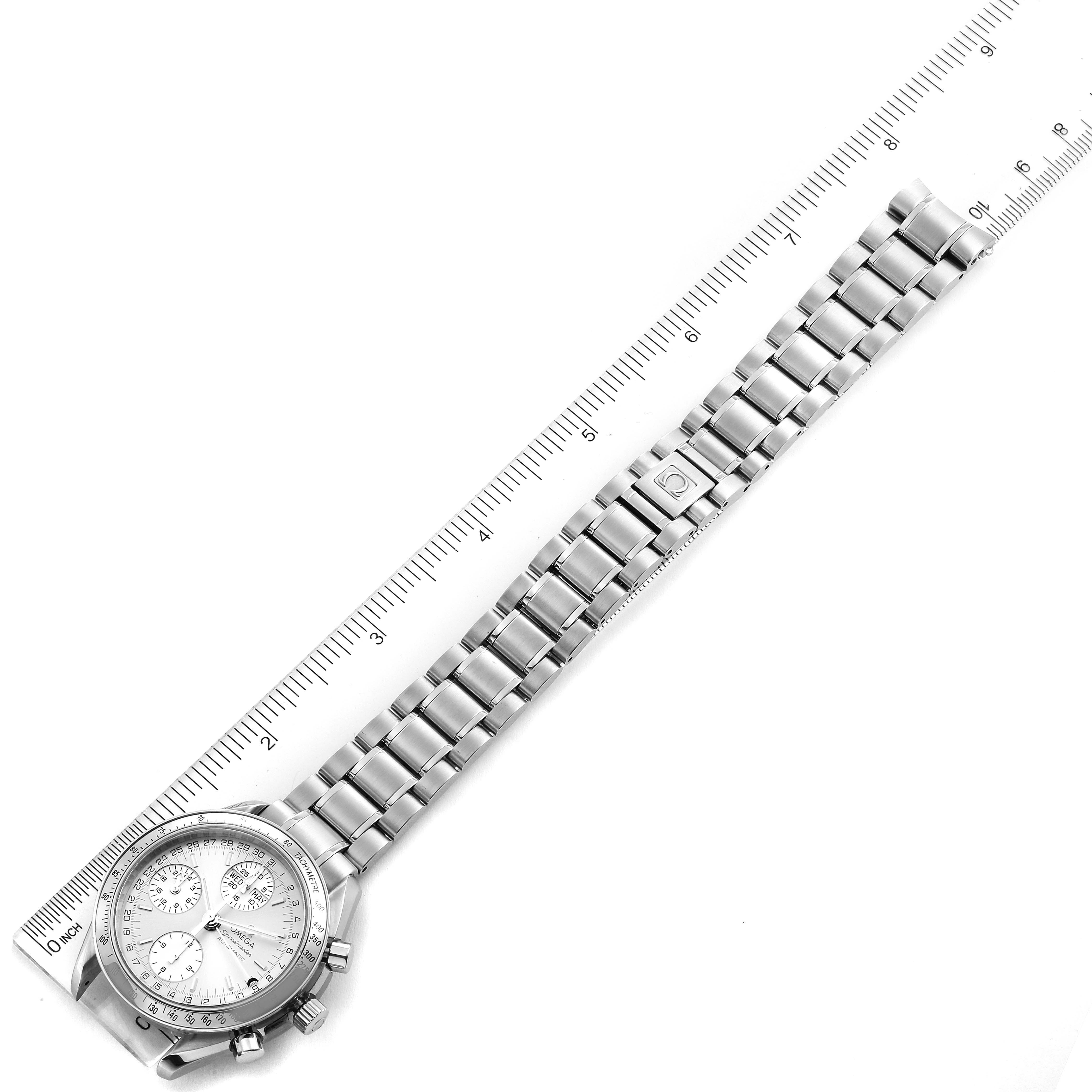 The image shows the Omega Speedmaster 3523.30.00 Men's Stainless Steel Silver Dial 3523.30.00 Men's Stainless Steel Silver Dial watch laid flat with a ruler next to its stainless steel bracelet for size reference.