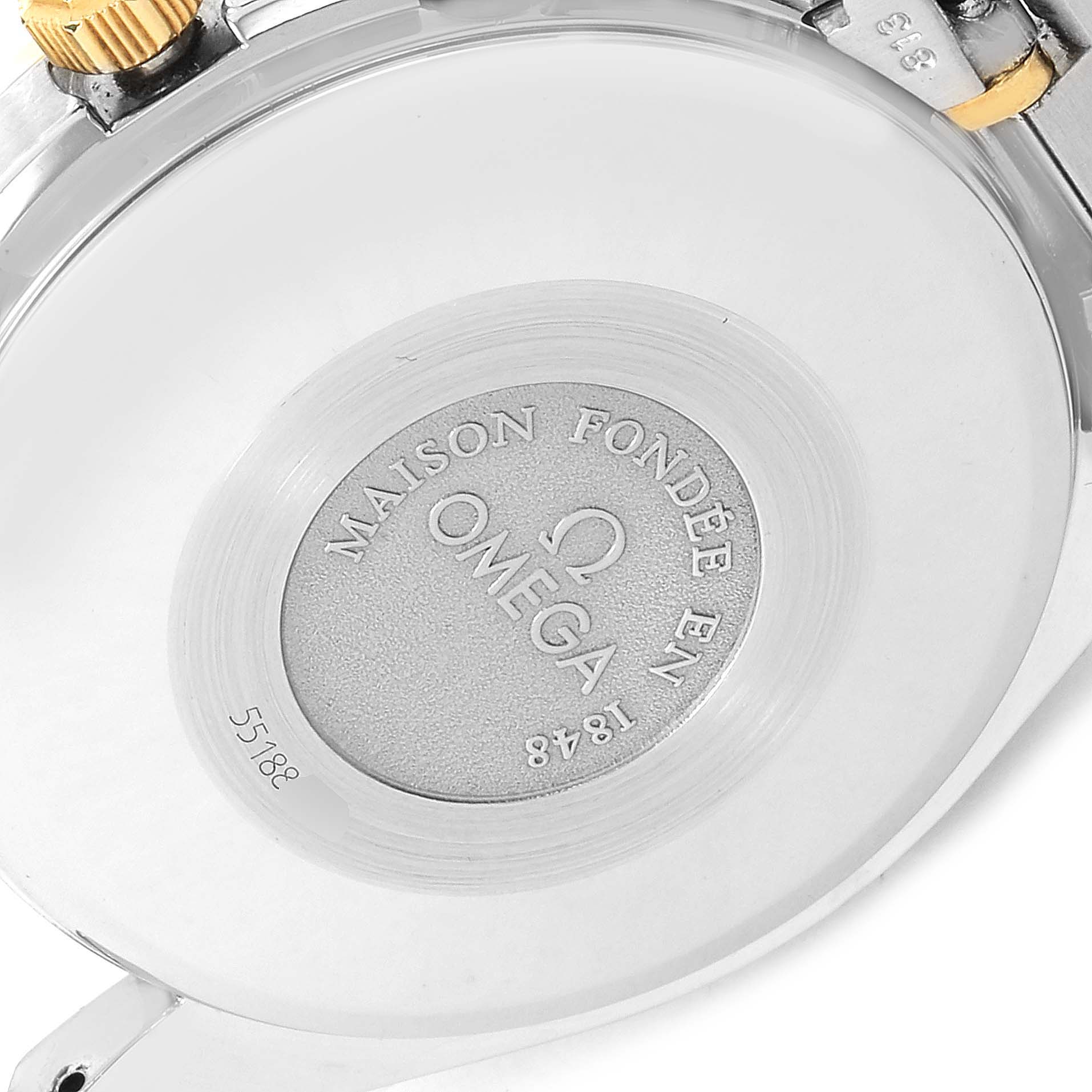 This image shows the backside of an Omega Speedmaster 3321.80.00 Men's Steel and Gold (two tone) Blue Dial 3321.80.00 Men's Steel and Gold (two tone) Blue Dial watch, featuring the brand's engraving and some serial numbers.