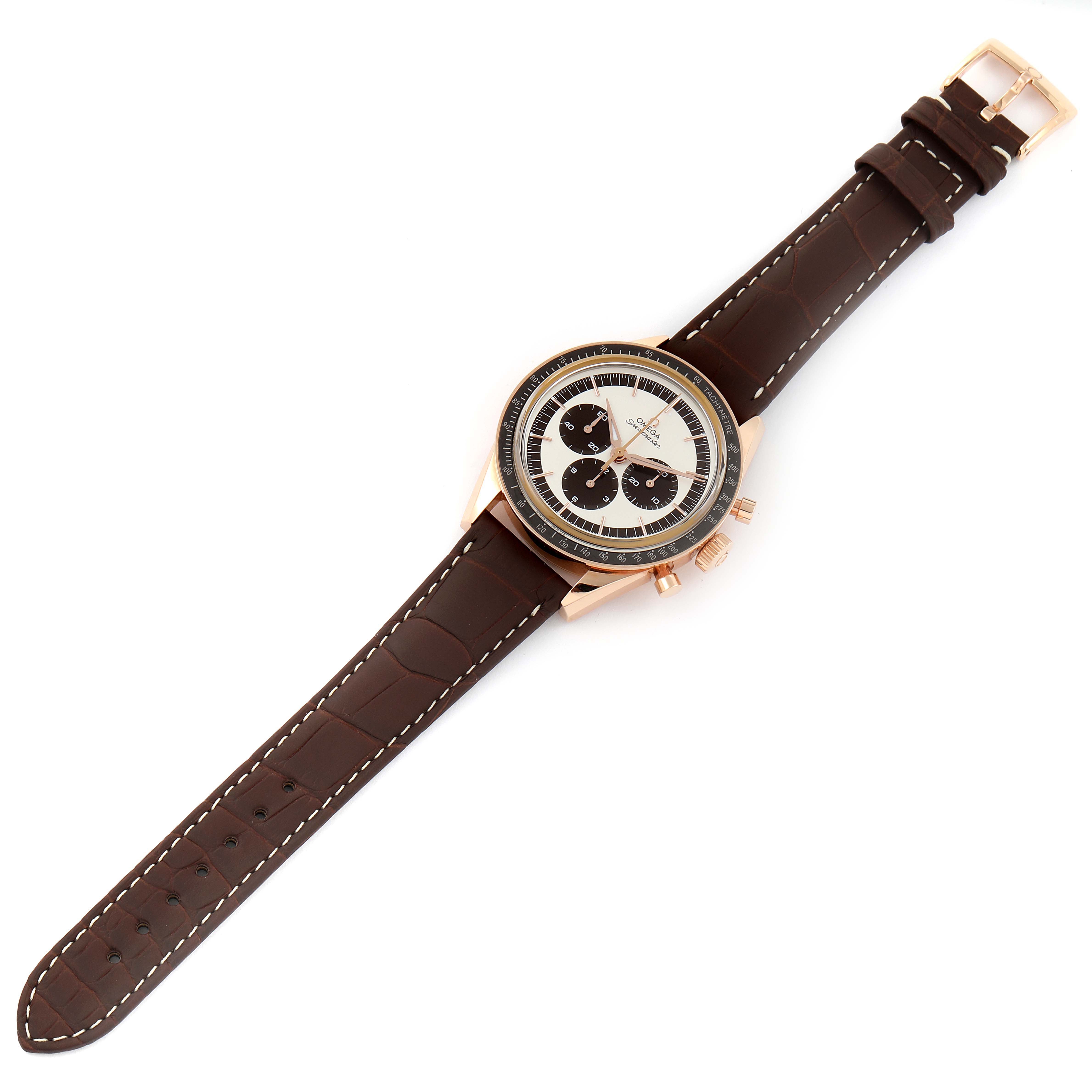 The Omega Speedmaster 311.63.40.30.02.001 Men's Rose Gold Silver Dial 311.63.40.30.02.001 Men's Rose Gold Silver Dial watch is shown from a top-down angle, featuring a brown leather strap and a rose gold case with a white and black dial.