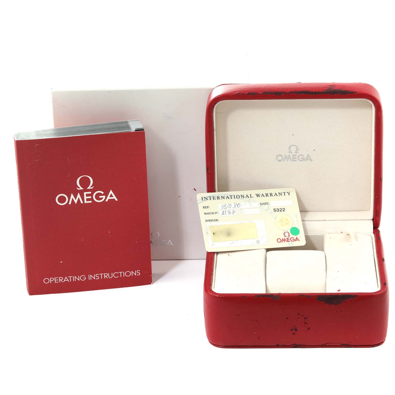 The image shows a red Omega Speedmaster 3510.80.00 Men
s Stainless Steel Blue Dial 3510.80.00 Men
s Stainless Steel Blue Dial watch box, an international warranty card, and an operating instructions booklet.