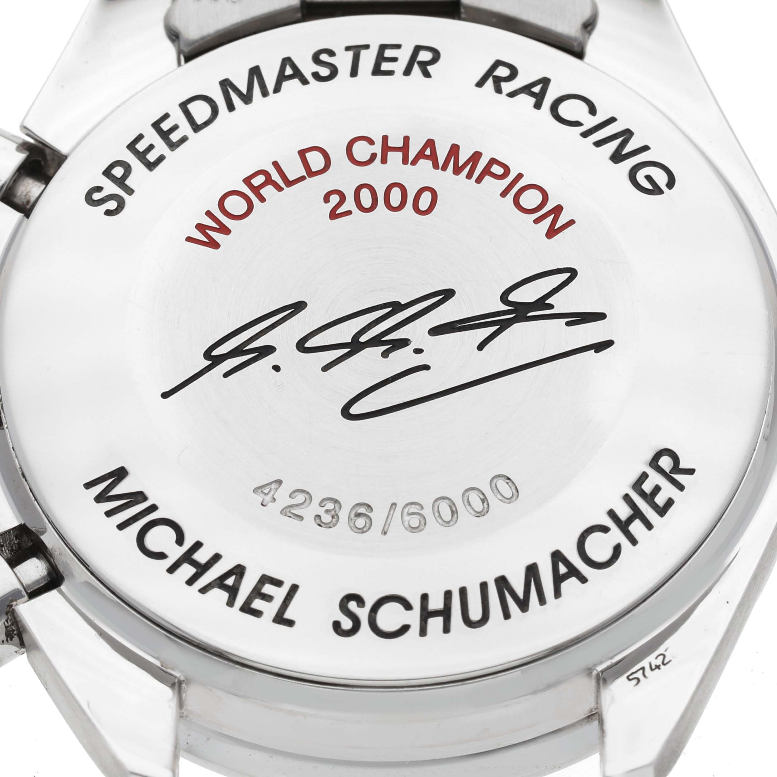 The image shows the back of an Omega Speedmaster 3518.50.00 Men's Stainless Steel Black Dial 3518.50.00 Men's Stainless Steel Black Dial Racing watch, displaying its commemorative engravings.