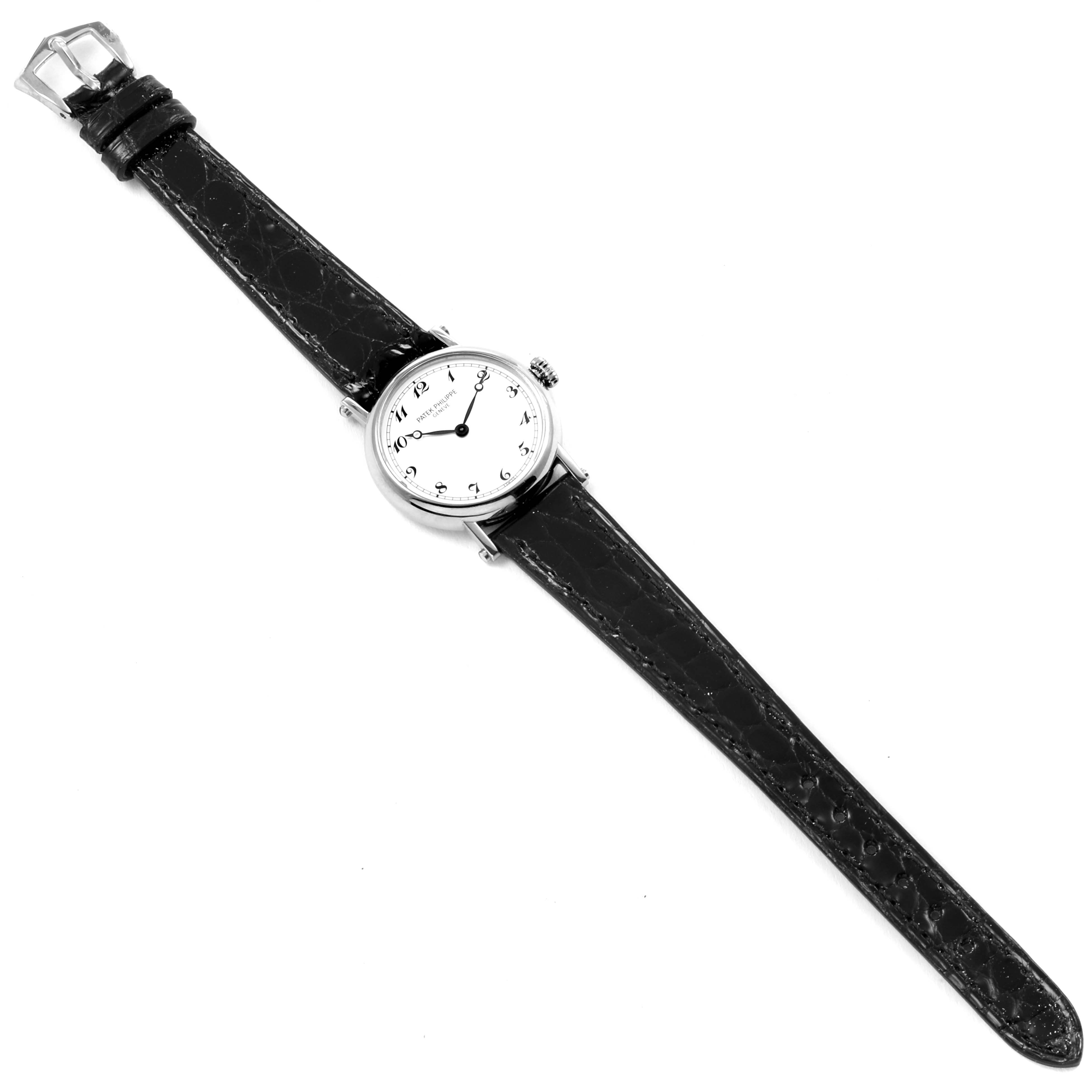 The image shows a top-down view of the Patek Philippe Calatrava 4860G Women's White Gold White Dial 4860G Women's White Gold White Dial watch, displaying the face, case, strap, and buckle.