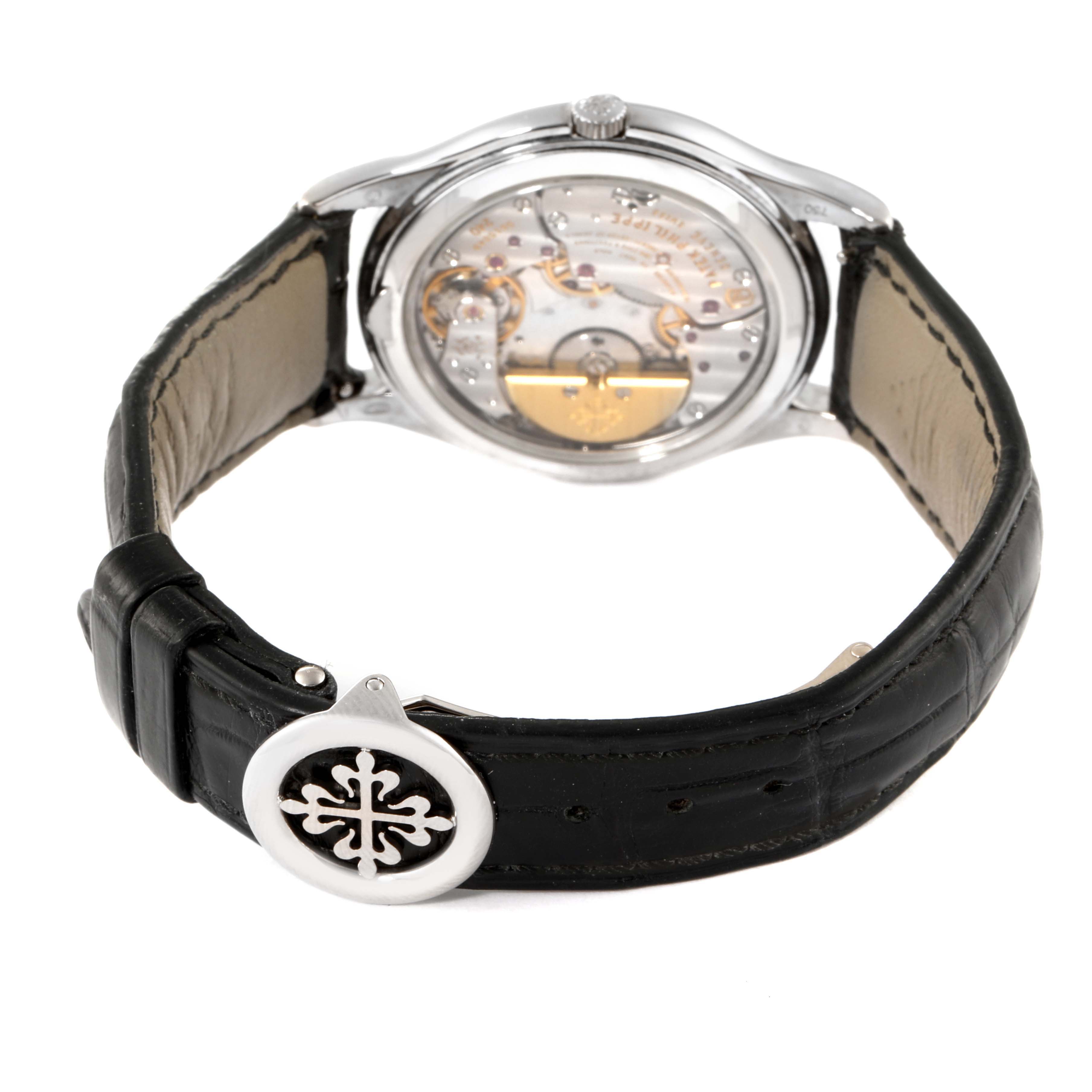 This image shows the rear angle of a Patek Philippe Calatrava 5140G-001 Men's White Gold Silver Dial 5140G-001 Men's White Gold Silver Dial watch, revealing its transparent case back and leather strap.