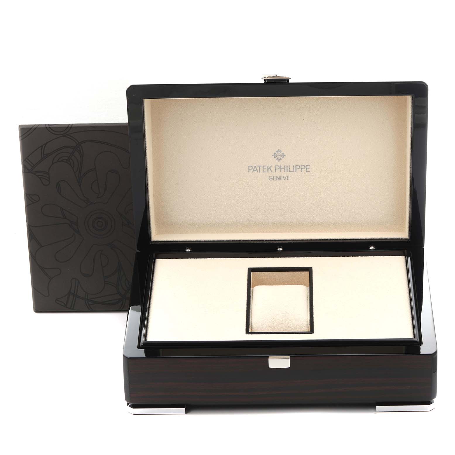 The image shows an open luxury box for a Patek Philippe Complications 5327G-001 Men
s White Gold Blue Dial 5327G-001 Men
s White Gold Blue Dial watch, displaying its interior and branding.