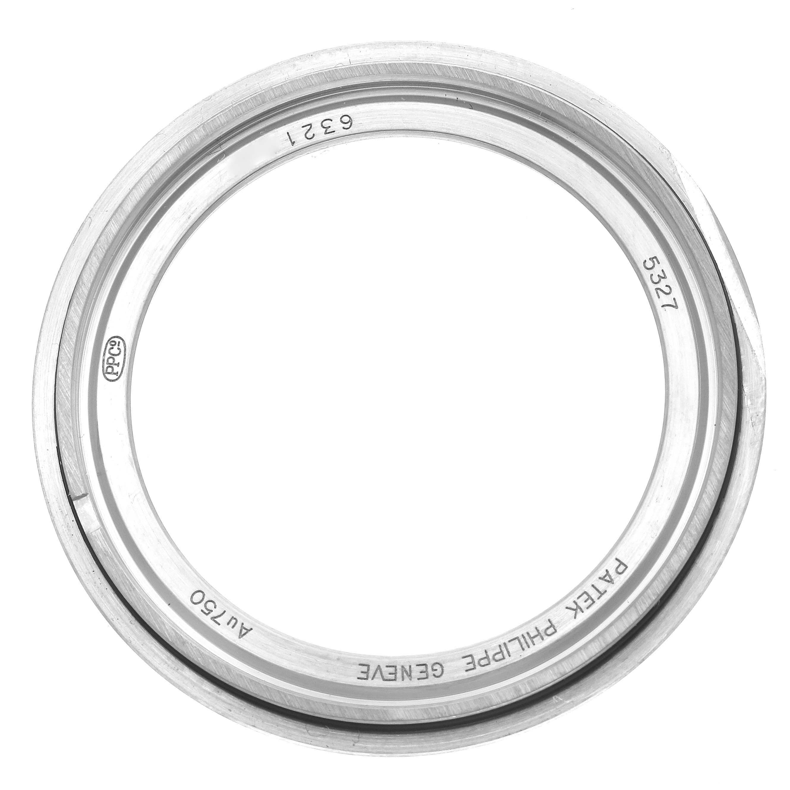 The image shows a bezel from a Patek Philippe Complications 5327G-001 Men
s White Gold Blue Dial 5327G-001 Men
s White Gold Blue Dial watch, viewed from above.