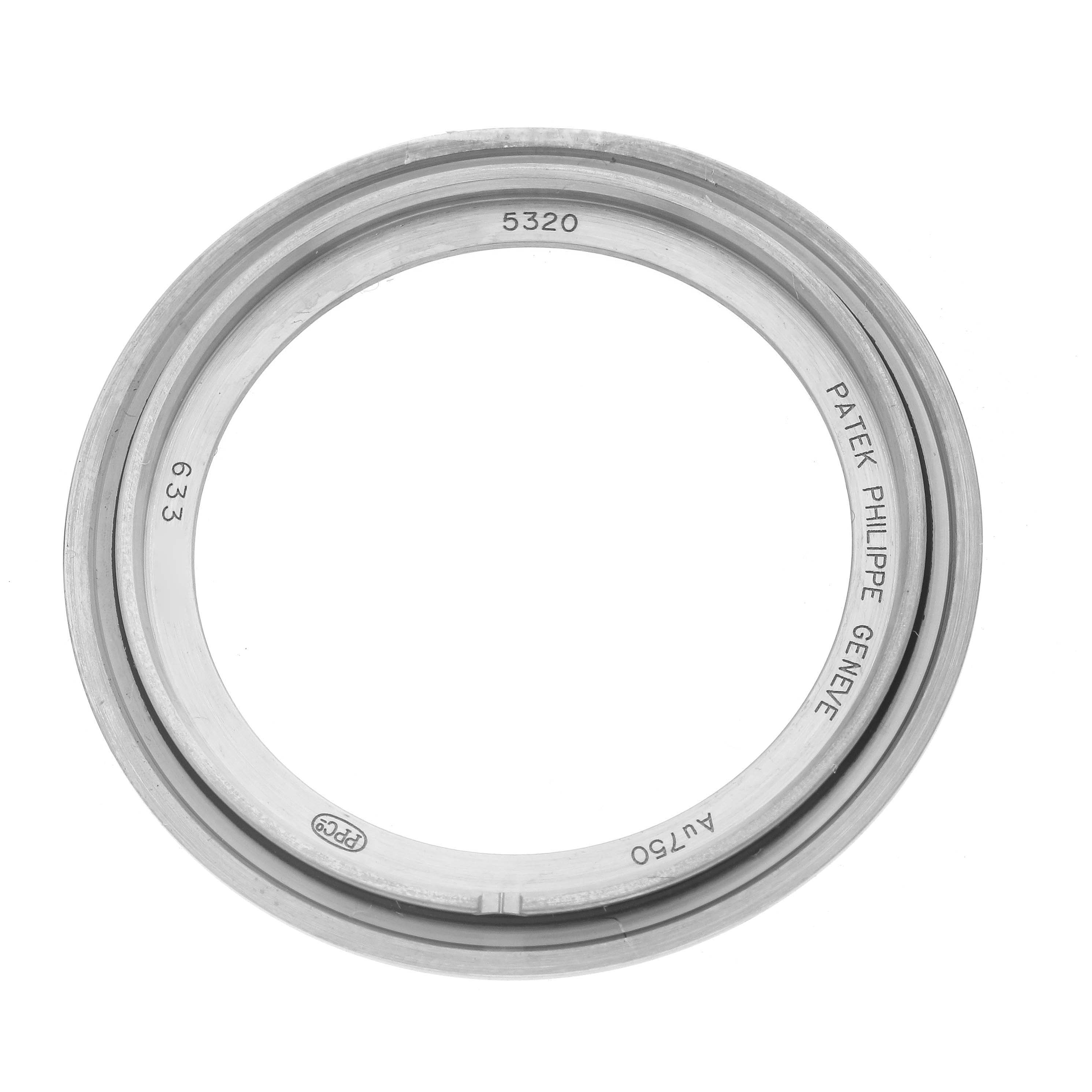 The image shows a top view of a Patek Philippe Complications 5320G-001 Men
s White Gold White Dial 5320G-001 Men
s White Gold White Dial model watch bezel with engraved details.