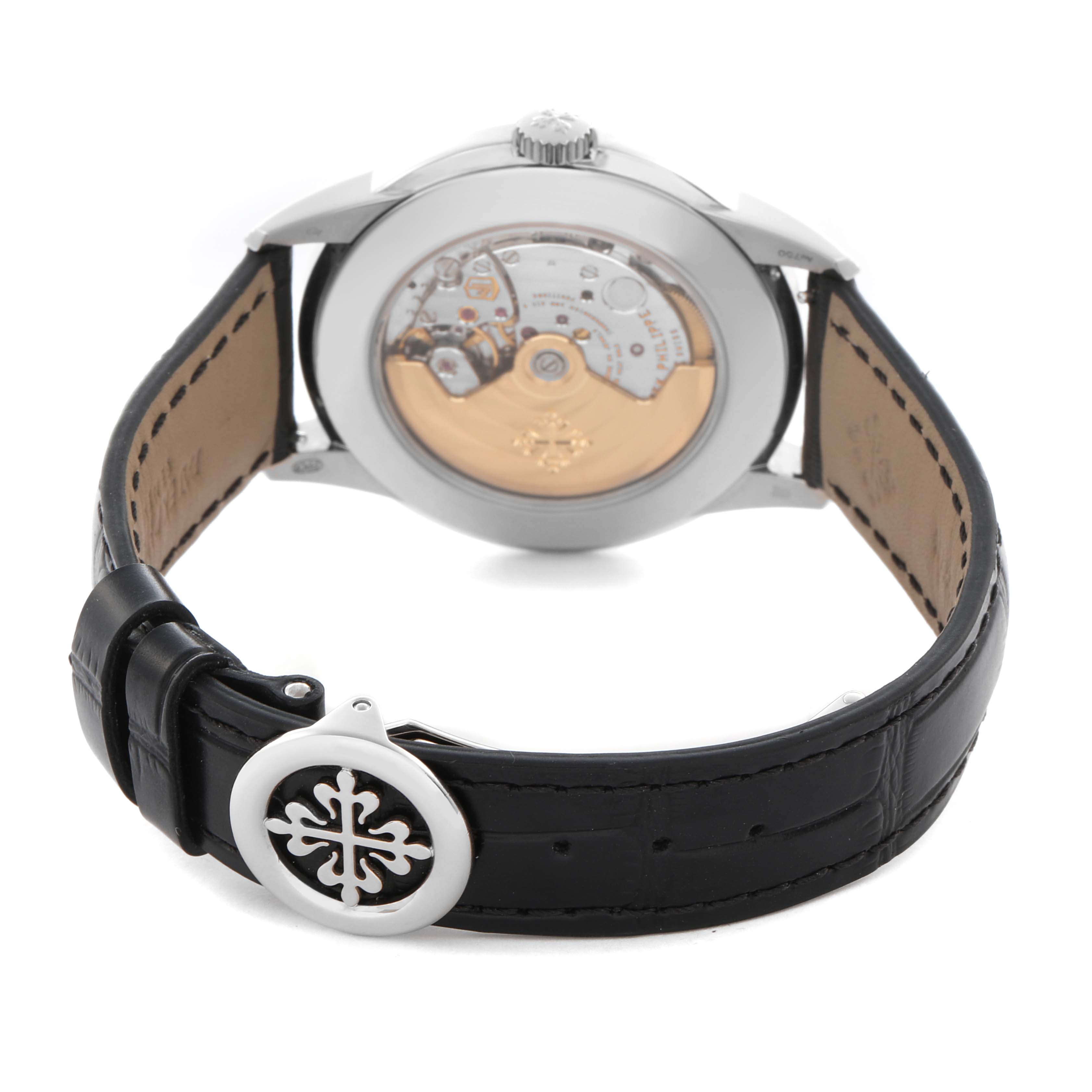 This Patek Philippe Complications 5320G-001 Men
s White Gold White Dial 5320G-001 Men
s White Gold White Dial watch is shown from the back, displaying the movement and a leather strap with a logo clasp.