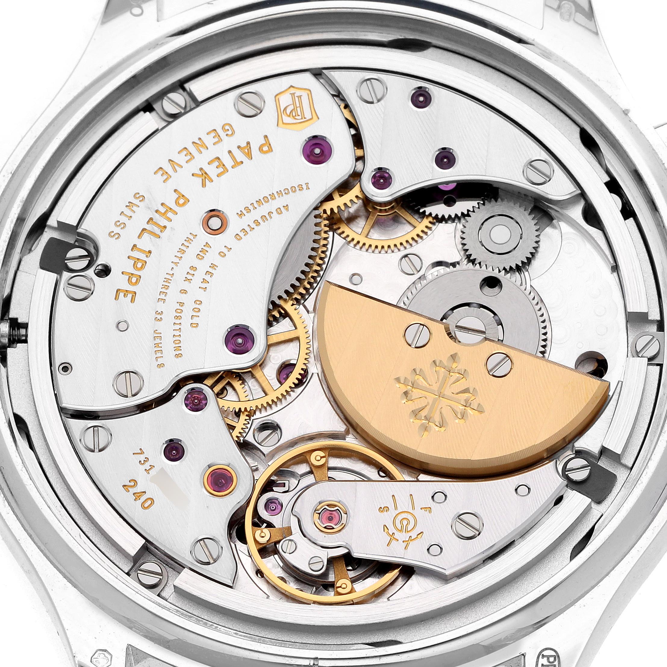 The image shows the movement from the back of the Patek Philippe Complications 7130G-016 Men
s White Gold Blue Dial 7130G-016 Men
s White Gold Blue Dial watch, highlighting gears and the rotor.