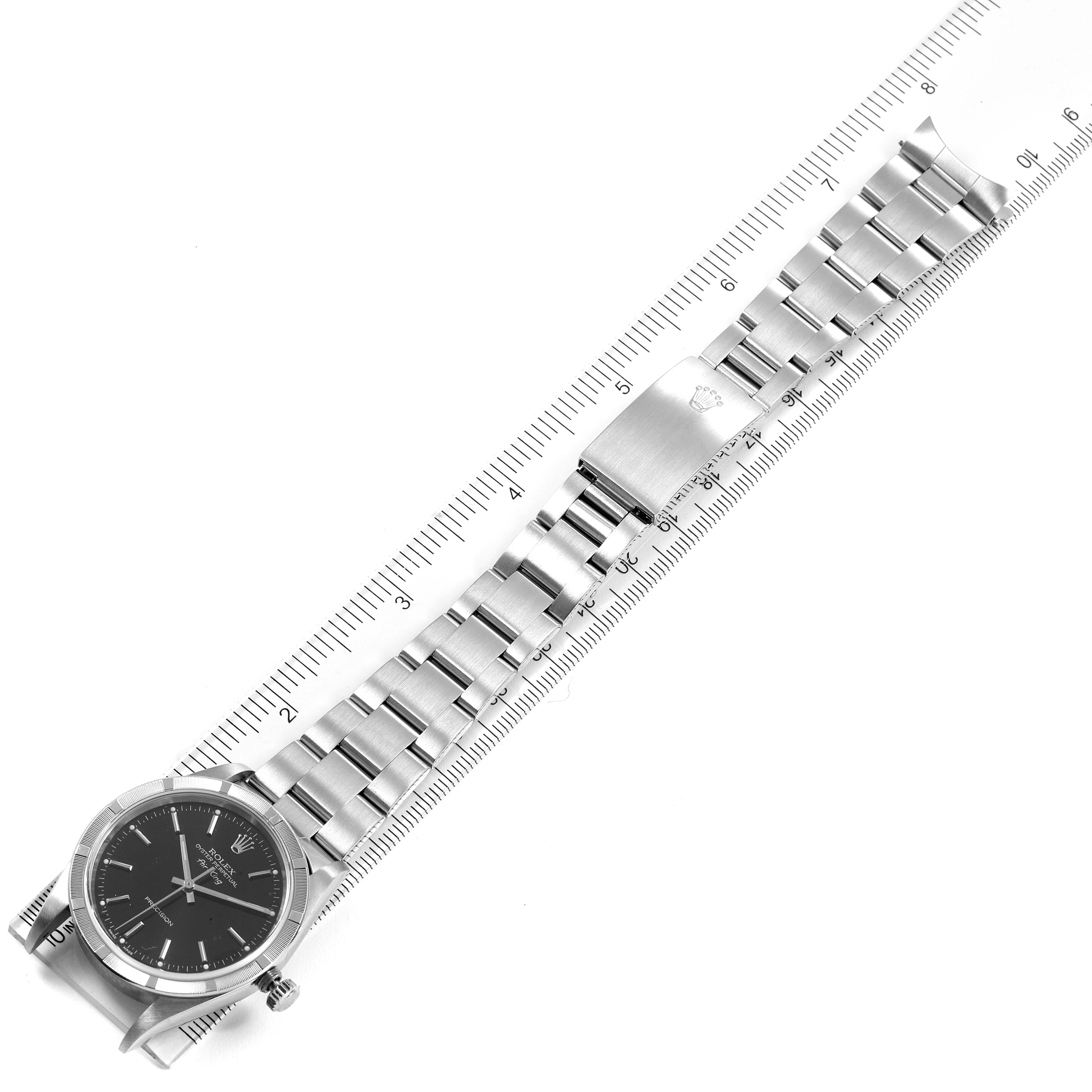 The image shows a Rolex Air-King 14010 Men's Stainless Steel Black Dial 14010 Men's Stainless Steel Black Dial watch laid flat with its bracelet fully extended along a ruler.