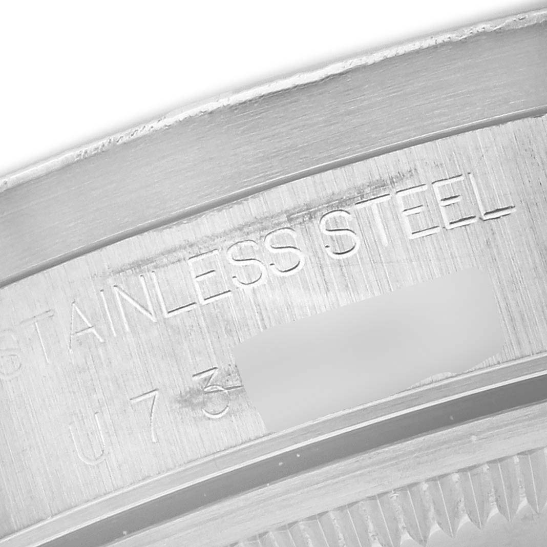The image shows a close-up of the stainless steel case back edge of an Air-King model by Rolex.