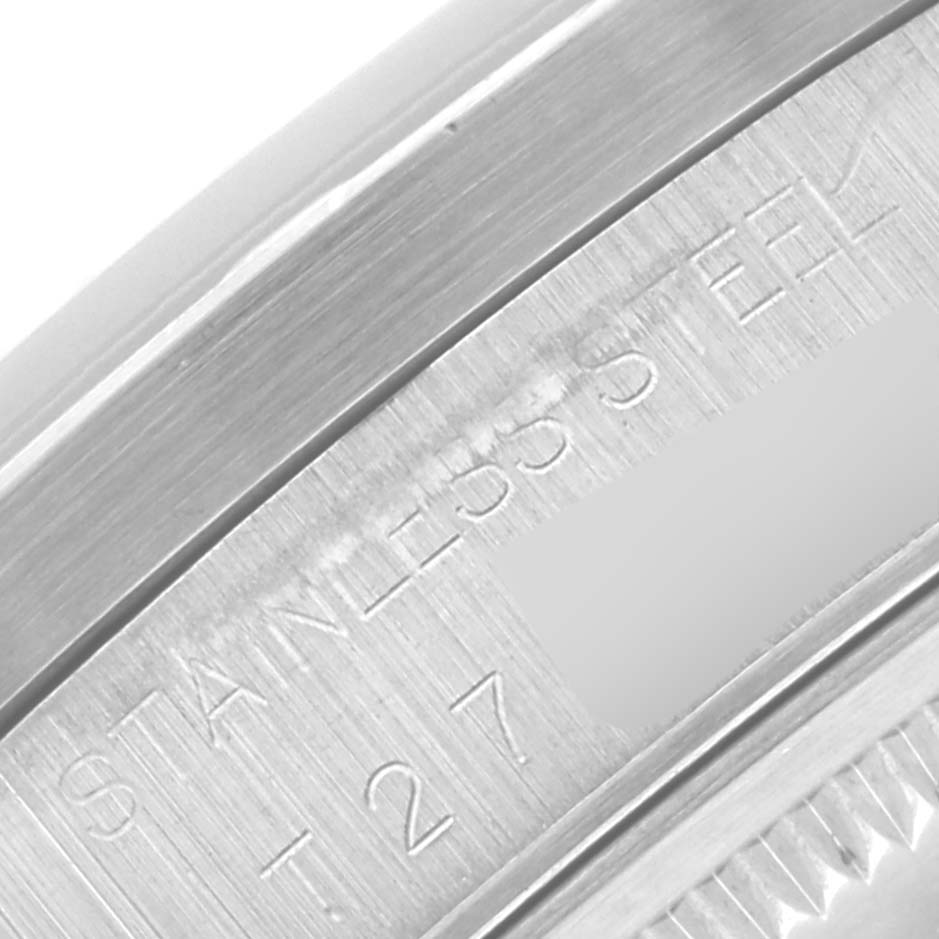 This close-up image of the Rolex Air-King 14010 Men's Stainless Steel Black Dial 14010 Men's Stainless Steel Black Dial watch shows the stainless steel casing with engraved text.