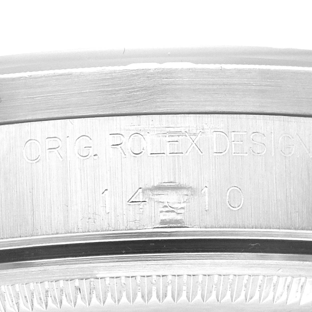 This image shows a close-up of the side of a Rolex Air-King 14010 Men's Stainless Steel Black Dial 14010 Men's Stainless Steel Black Dial watch case, focusing on the engraved markings.