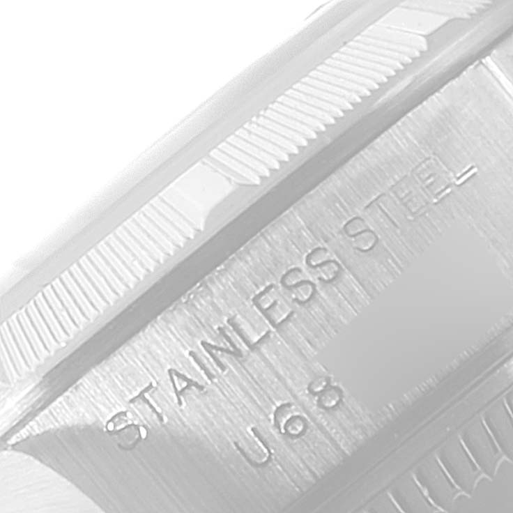 The image shows a close-up of the side of a Rolex Date 69190 Women's Stainless Steel Black Dial 69190 Women's Stainless Steel Black Dial model watch, highlighting its stainless steel engraving.