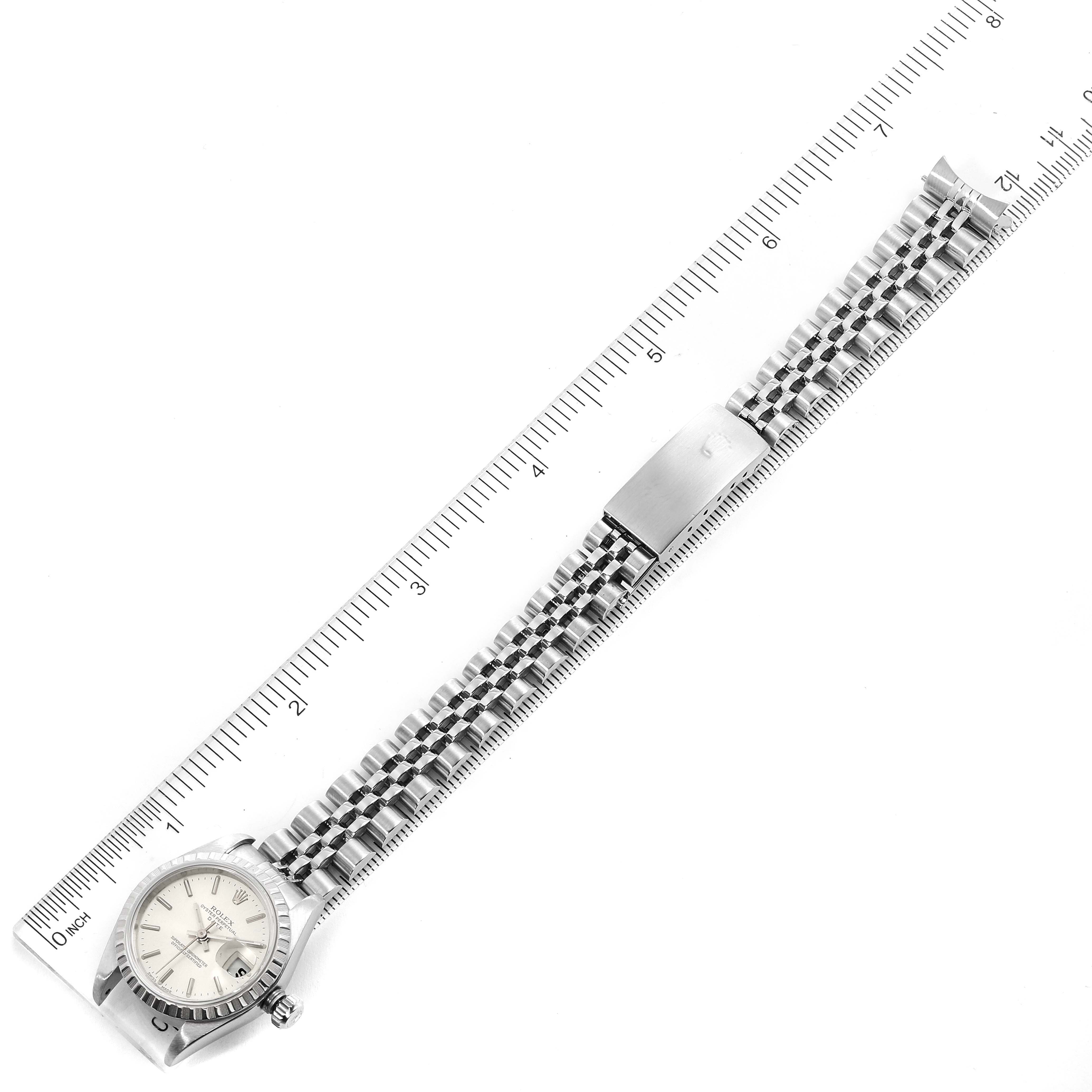 The Rolex Datejust 79240 Women's Stainless Steel Silver Dial 79240 Women's Stainless Steel Silver Dial watch is shown from a top-down angle alongside a ruler, displaying the face and entire bracelet.