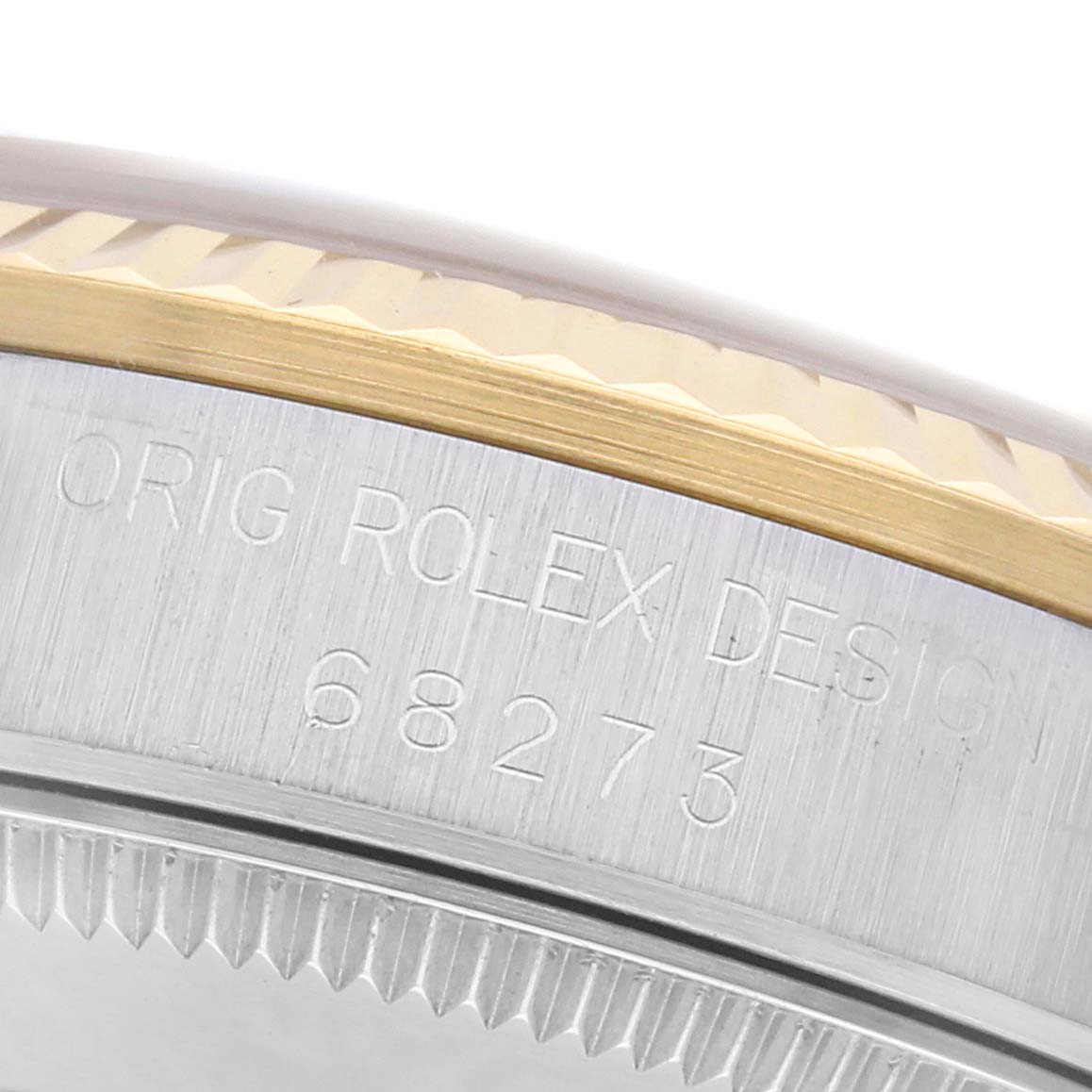 The image shows a close-up of the edge and side engraving on a Rolex Mid-Size 68273 Women
s Steel and Gold (two tone) Champagne Dial 68273 Women
s Steel and Gold (two tone) Champagne Dial model with the number 68273.
