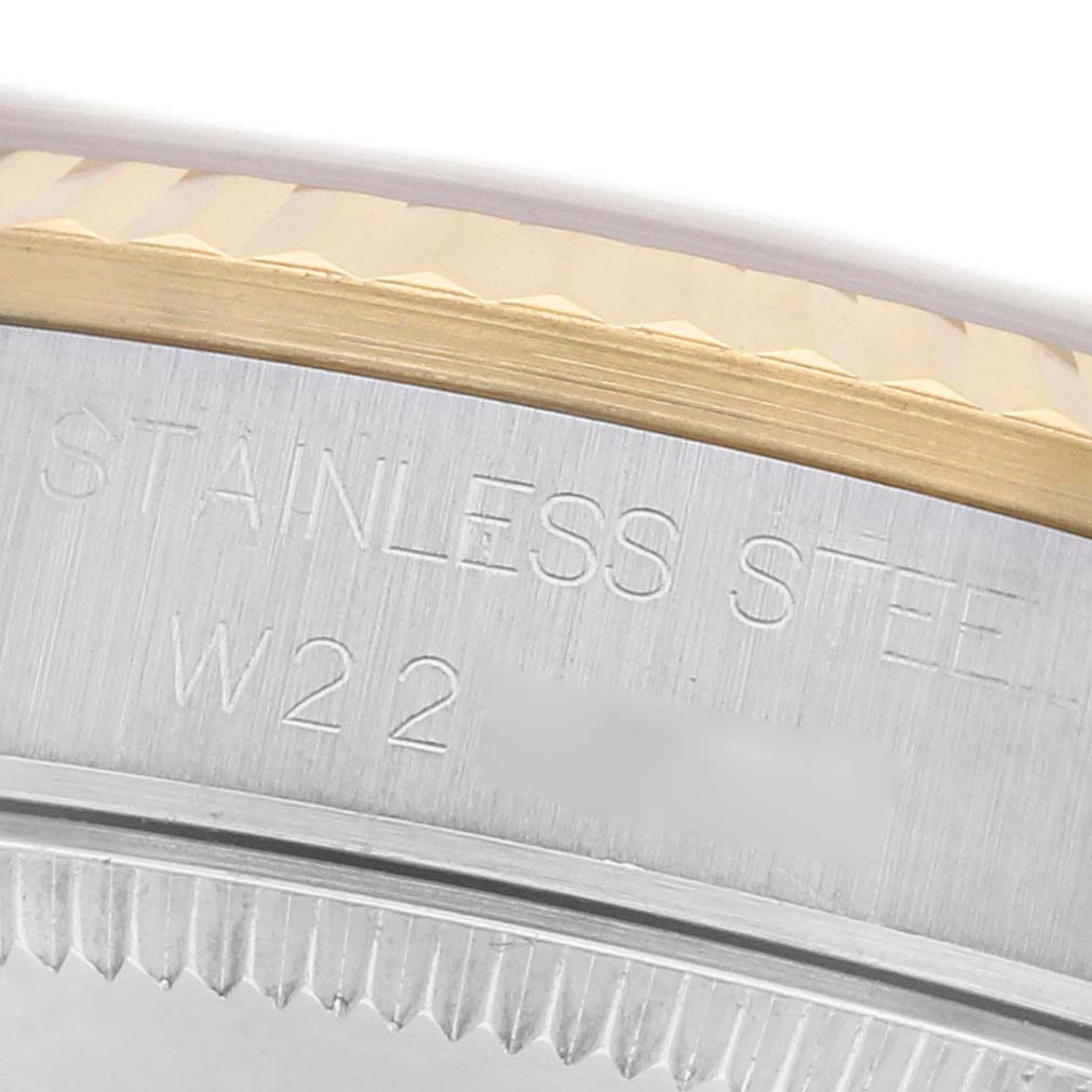 The image shows a close-up of the case back and fluted bezel of a Rolex Mid-Size 68273 Women
s Steel and Gold (two tone) Champagne Dial 68273 Women
s Steel and Gold (two tone) Champagne Dial watch, with "STAINLESS STEEL" engravings visible.