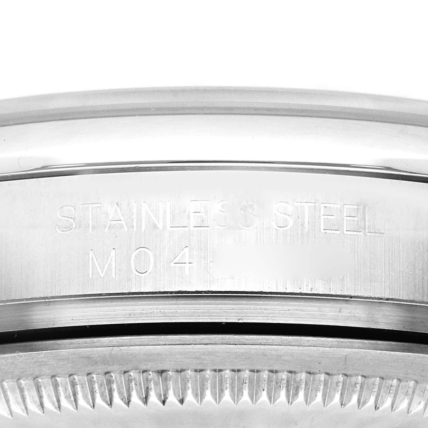 The image shows a close-up of the engraved side of the Rolex Datejust 116200 Men's Stainless Steel Black Dial 116200 Men's Stainless Steel Black Dial's stainless steel case.