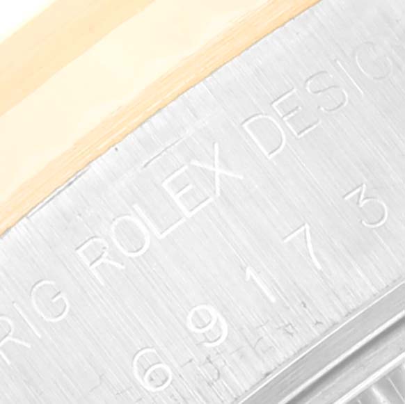 Close-up of the serial and model number engraving on the side of a Rolex Datejust 69173 Women's Steel and Gold (two tone) White Dial 69173 Women's Steel and Gold (two tone) White Dial watch.