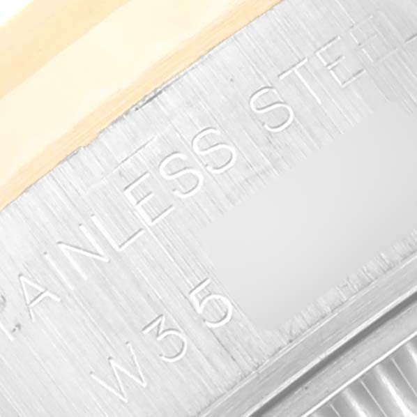 The image shows a close-up of the bezel and case of a Rolex Datejust 69173 Women's Steel and Gold (two tone) White Dial 69173 Women's Steel and Gold (two tone) White Dial watch, highlighting the "STAINLESS STEEL" engraving.