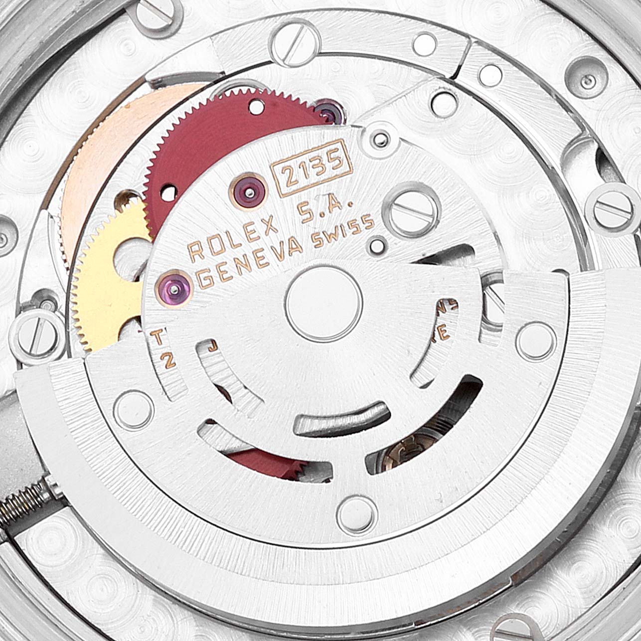 The image shows the inner mechanism of a mid-size Rolex watch movement, focusing on the gears and rotor.