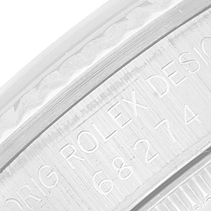 The image shows a close-up of the engraved edge on the case back of a Mid-Size Rolex watch.
