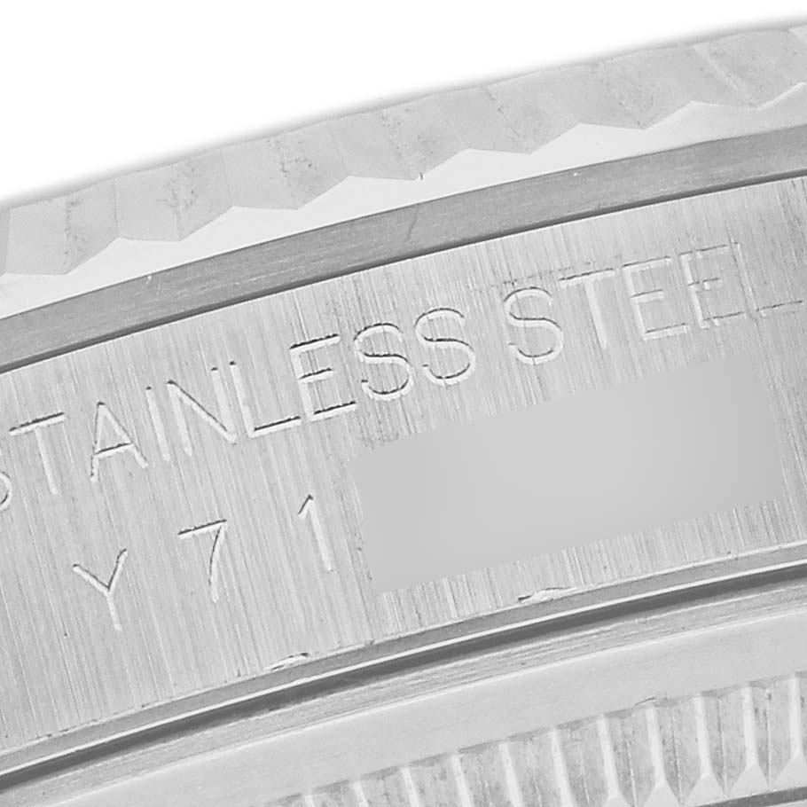 This close-up image shows the fluted bezel and engraved text on the side of a Rolex Datejust 16234 Men's Stainless Steel Silver Dial 16234 Men's Stainless Steel Silver Dial watch.