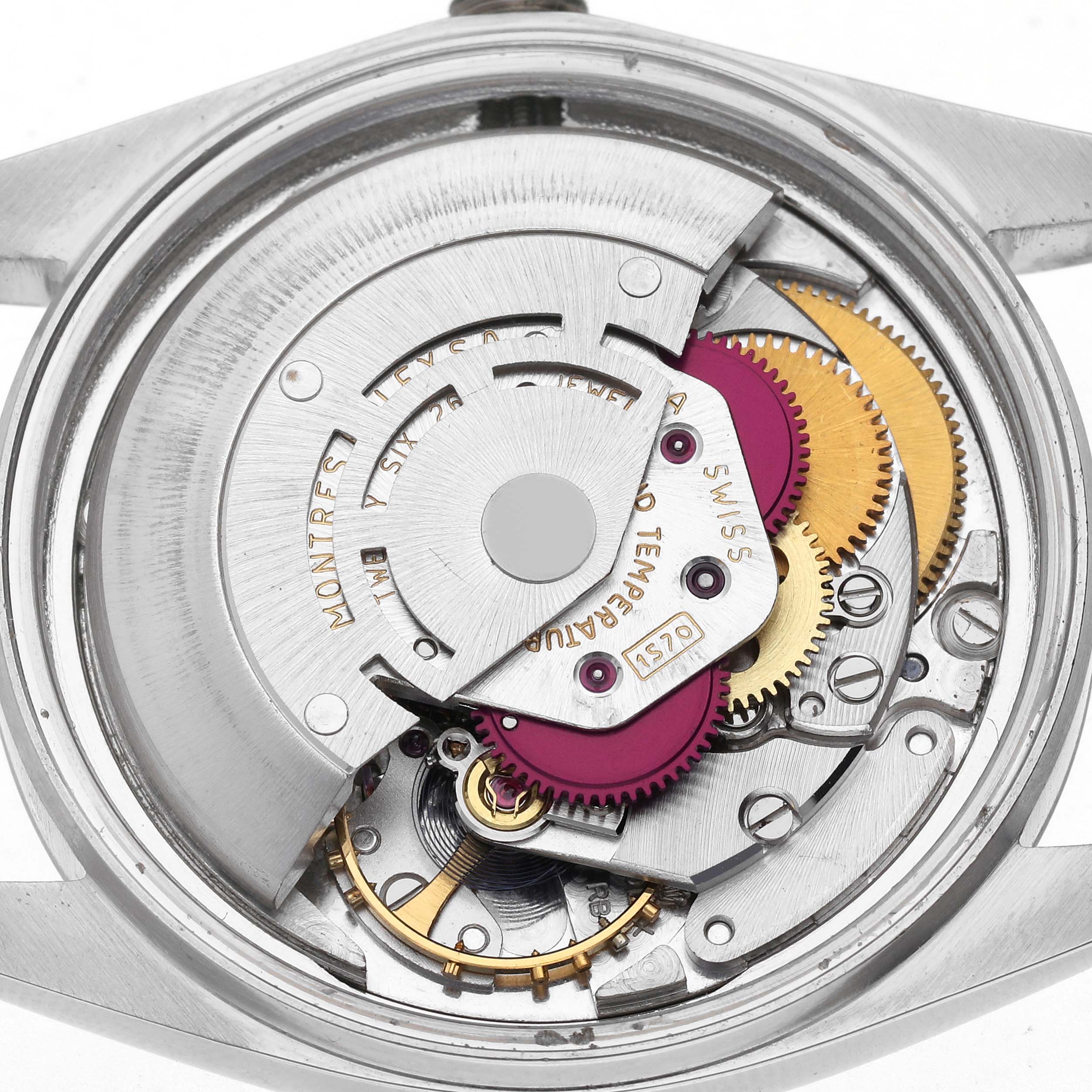 The image shows the internal movement of a Rolex Datejust 1601 Men
s Stainless Steel Blue Dial 1601 Men
s Stainless Steel Blue Dial watch, highlighting gears and mechanical components from a top-down angle.