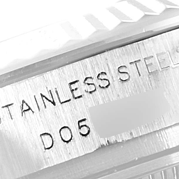 This close-up image of a Rolex Datejust 179174 Women's Stainless Steel Mother of Pearl Dial 179174 Women's Stainless Steel Mother of Pearl Dial watch showcases the stainless steel inscription and part of the watch bezel.