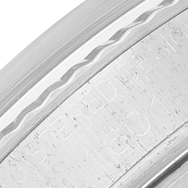 A close-up of the engraved bezel of the Vintage Collection model by Rolex is shown at an angled view.