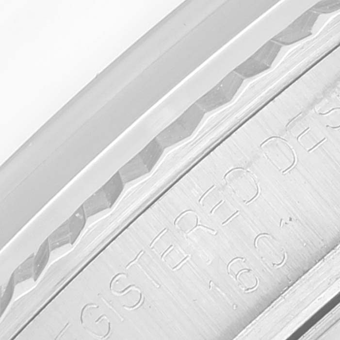 The image shows a close-up of the textured bezel and engraved side of a Vintage Collection Rolex watch.