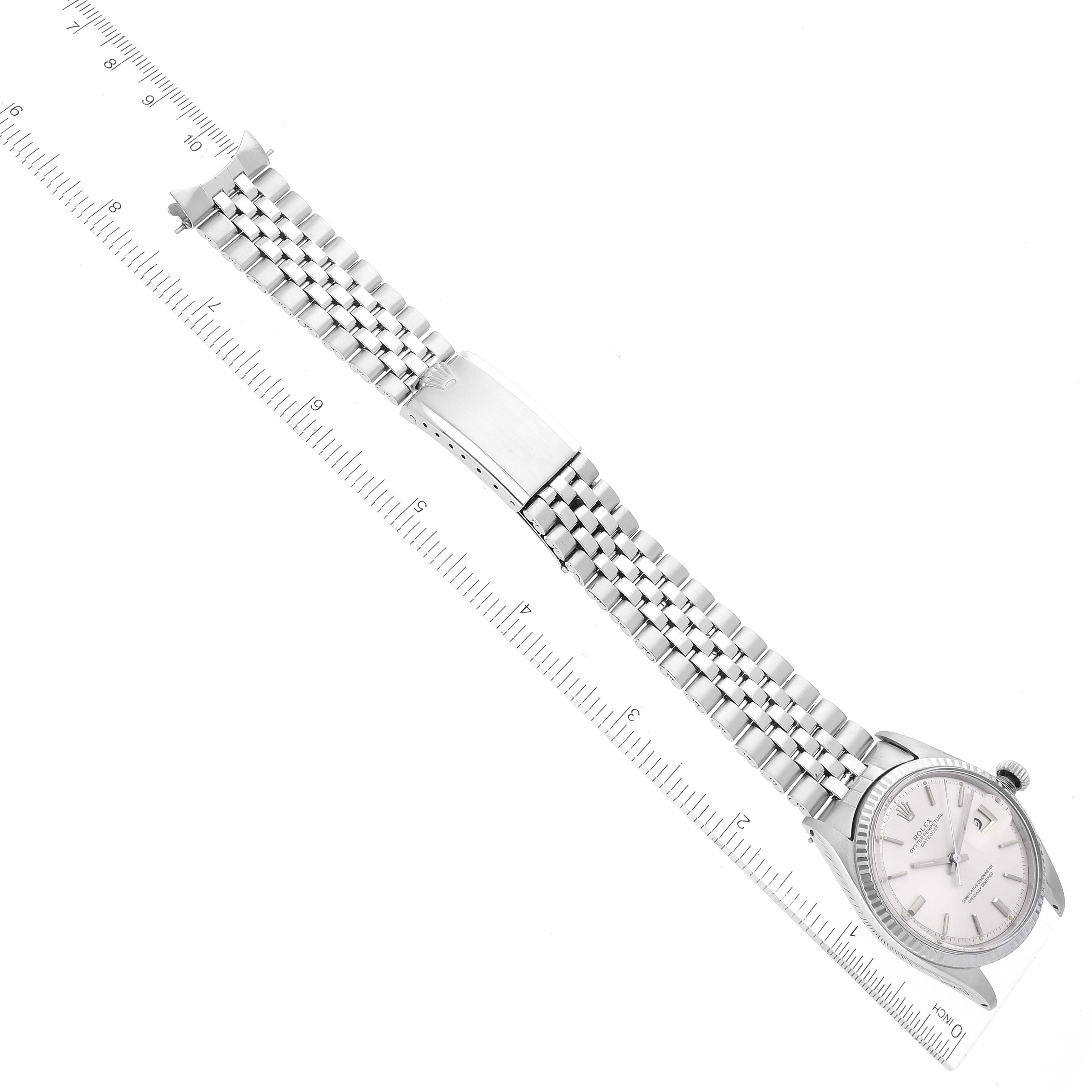 The image shows a Rolex Vintage Collection 1601 Men's Stainless Steel Silver Dial 1601 Men's Stainless Steel Silver Dial watch from a top-down angle, displaying the face, bracelet, and clasp with a ruler for scale.