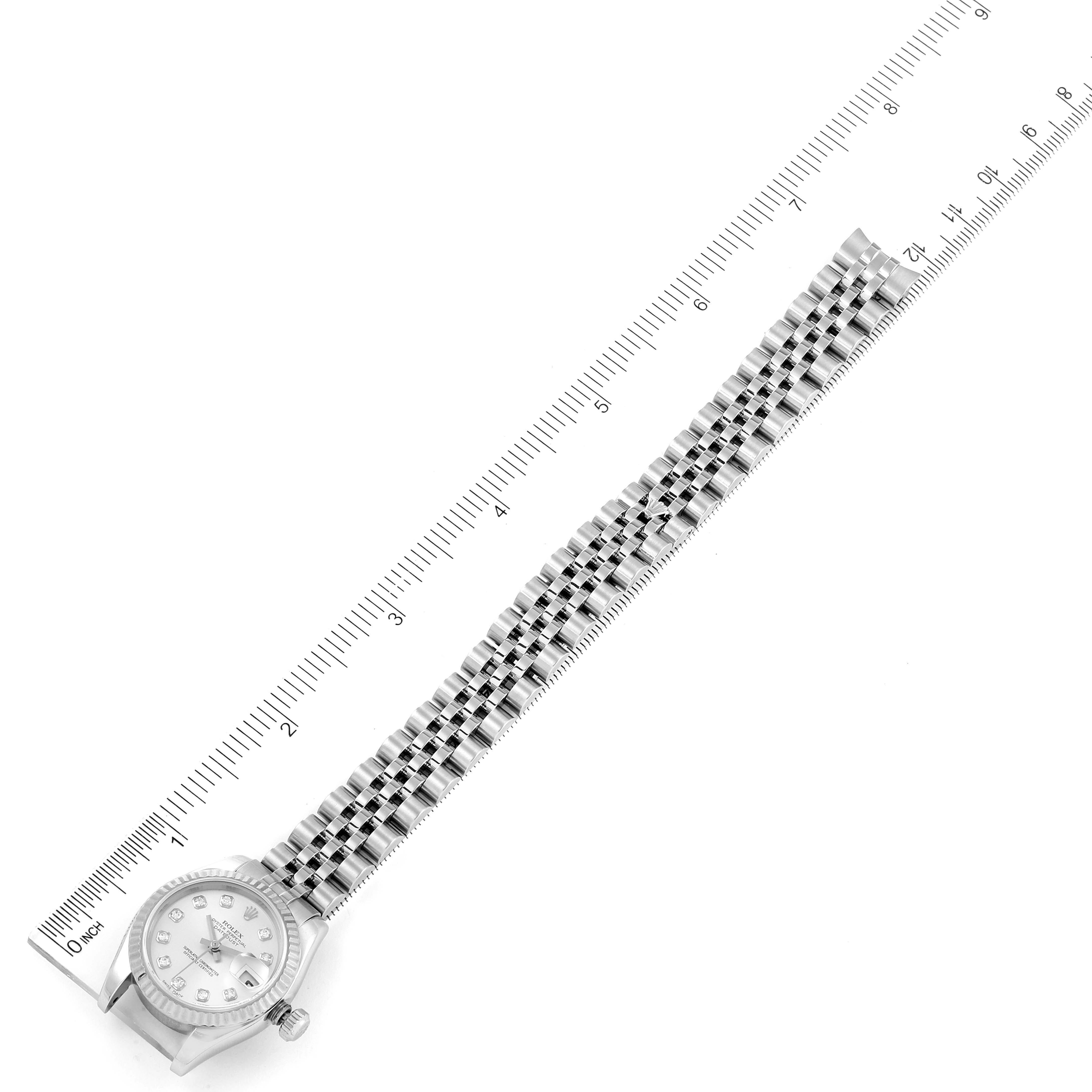 The image shows a top-down view of a Rolex Datejust 179174 Women's Stainless Steel Silver Dial 179174 Women's Stainless Steel Silver Dial watch with its bracelet laid flat next to a ruler for measurement.