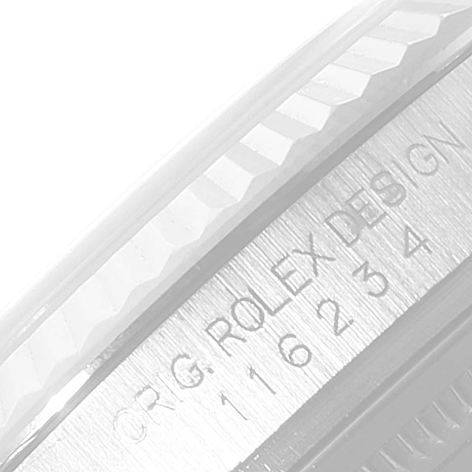 This is a close-up of the bezel and case of a Rolex Datejust 116234 Men's Stainless Steel White Dial 116234 Men's Stainless Steel White Dial watch, showing the engraved model number and "ROLEX DESIGN."