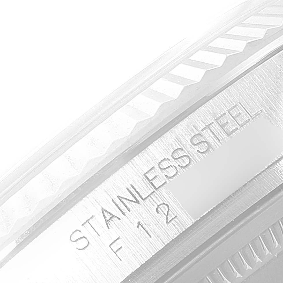 The image shows a close-up of a fluted bezel with the "STAINLESS STEEL" engraving on a Rolex Datejust 116234 Men's Stainless Steel White Dial 116234 Men's Stainless Steel White Dial watch.